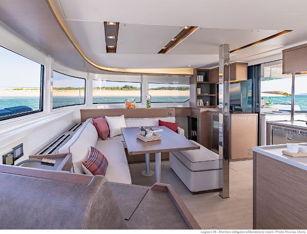 Luxurious interior of 2025 Lagoon 46 ICONIC yacht with modern furnishings and panoramic windows.