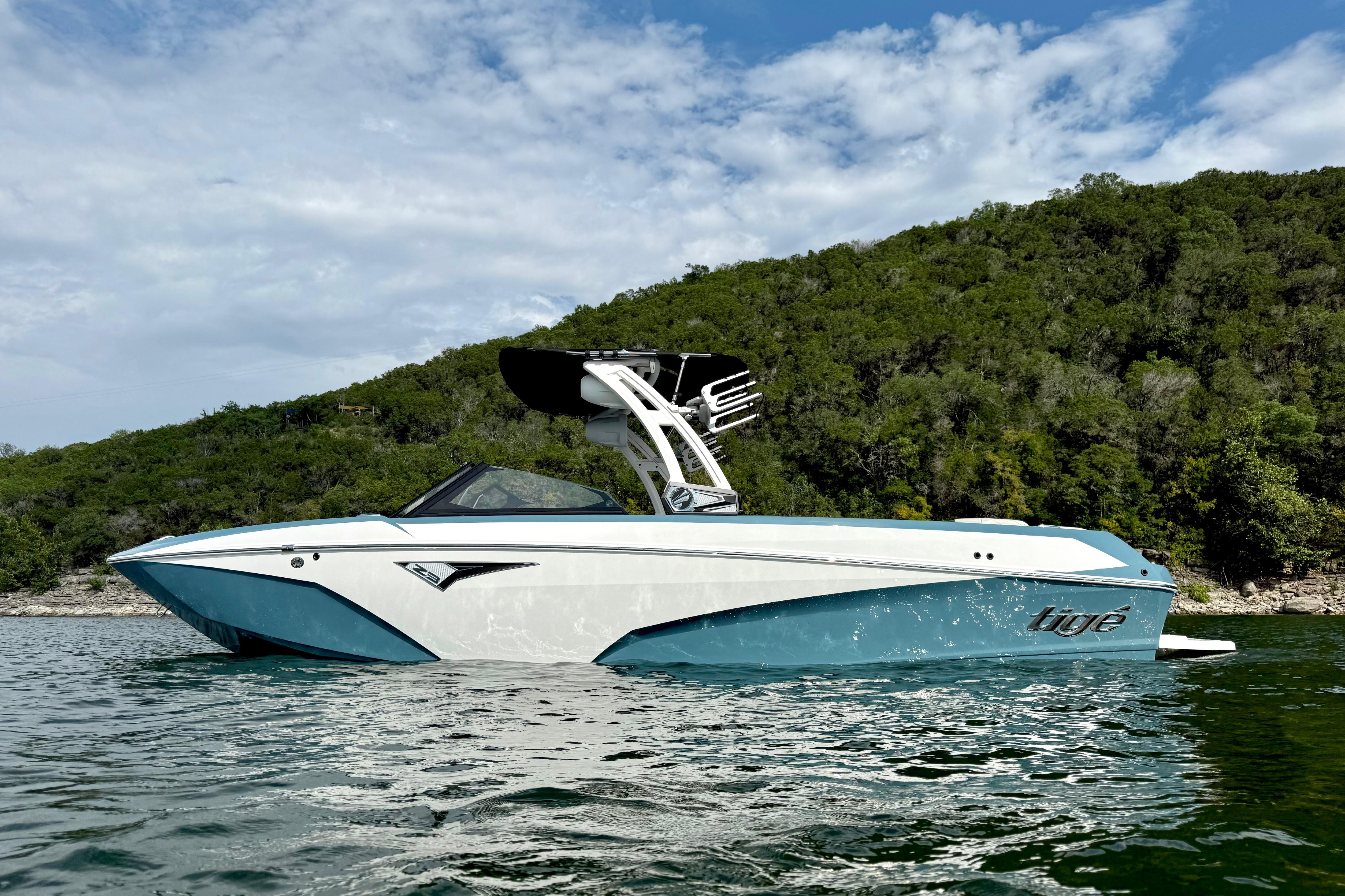 2021 Tige Z3 boat on water with lush green hillside background.