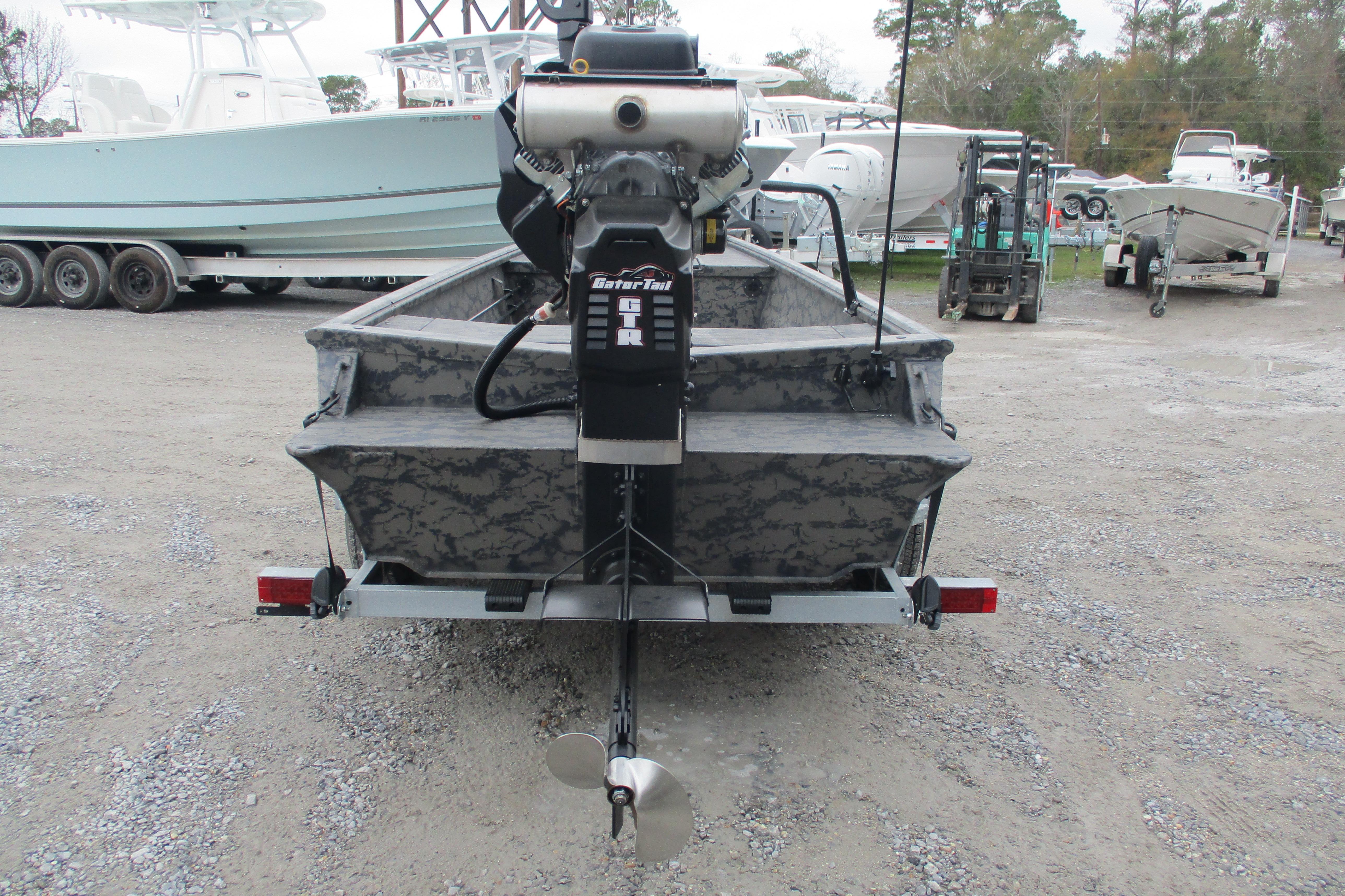 2026 Gator Tail 1754 Extreme boat with motor, parked on gravel lot.