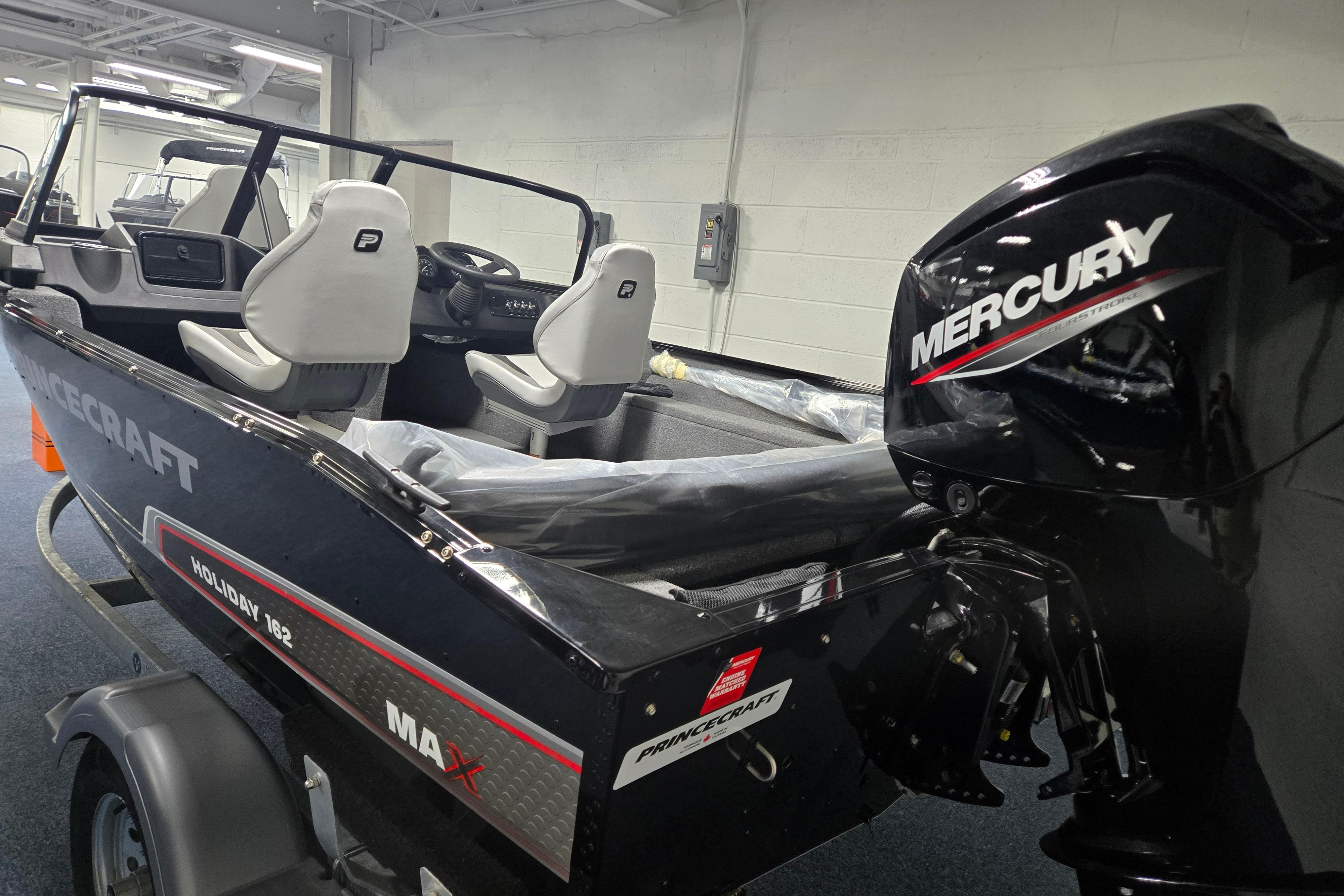 2026 Princecraft Holiday 162 WS MAX boat with Mercury engine in showroom.