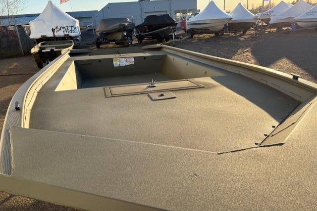 2026 Tracker Grizzly 1754 Utility boat in outdoor storage, surrounded by covered boats.