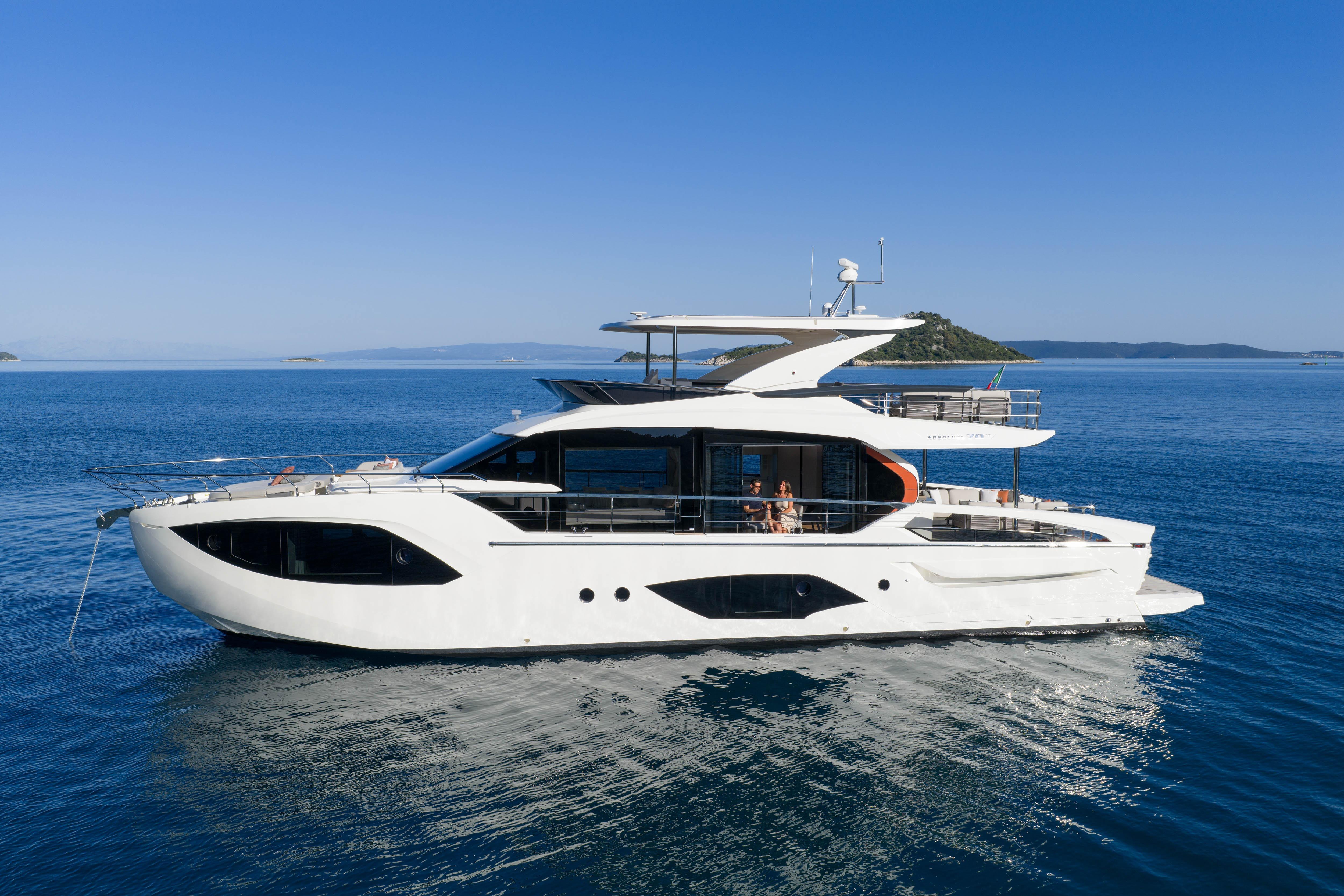 Luxury yacht on calm sea with clear sky, modern architecture, and spacious deck.
