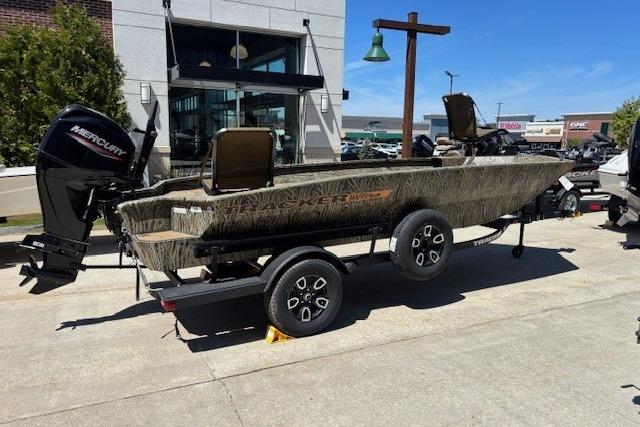 2026 Tracker Grizzly 1756 T Marsh boat on trailer, outdoors, with Mercury engine.
