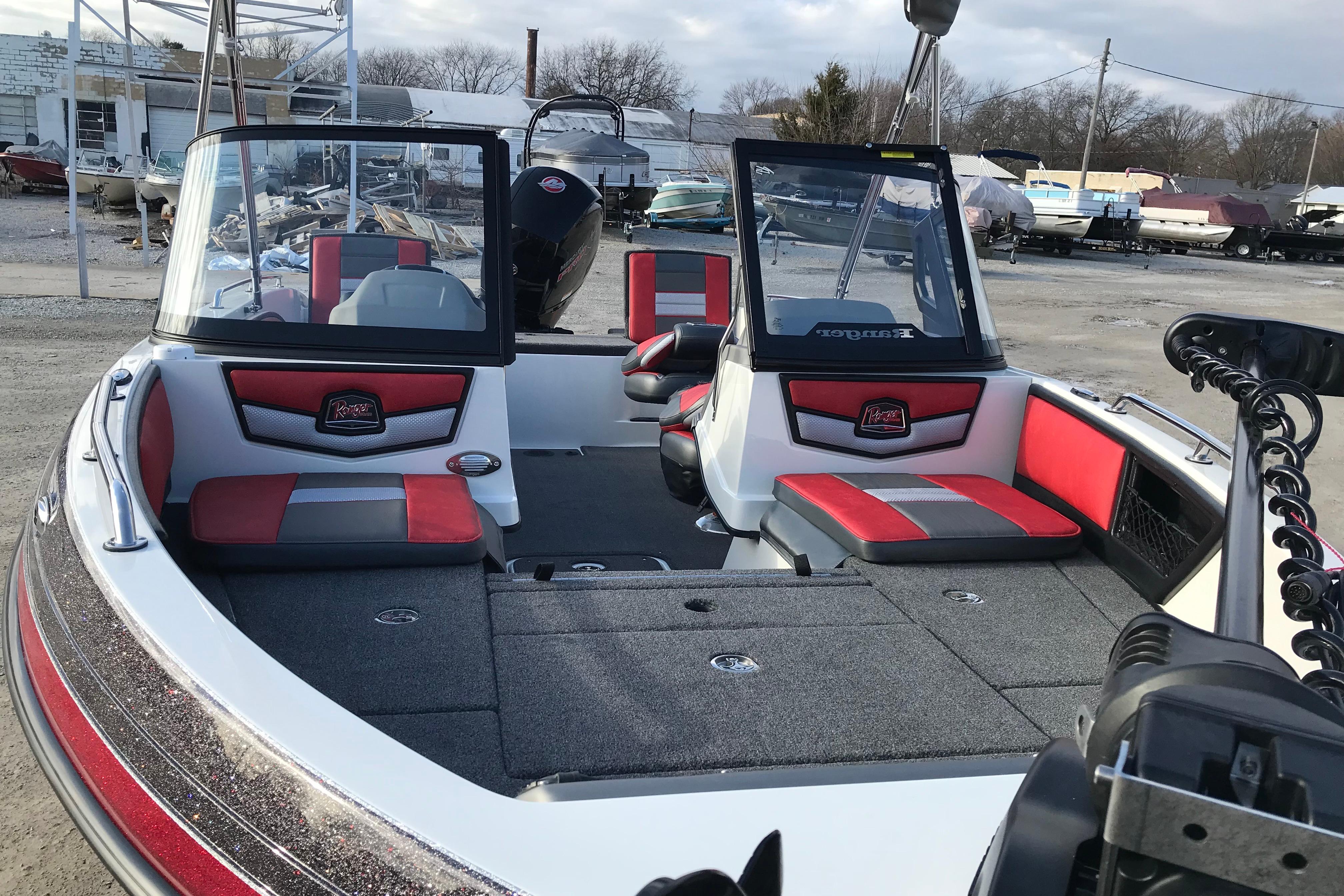 2026 Ranger 1850MS boat interior with red and gray seating, parked outdoors.