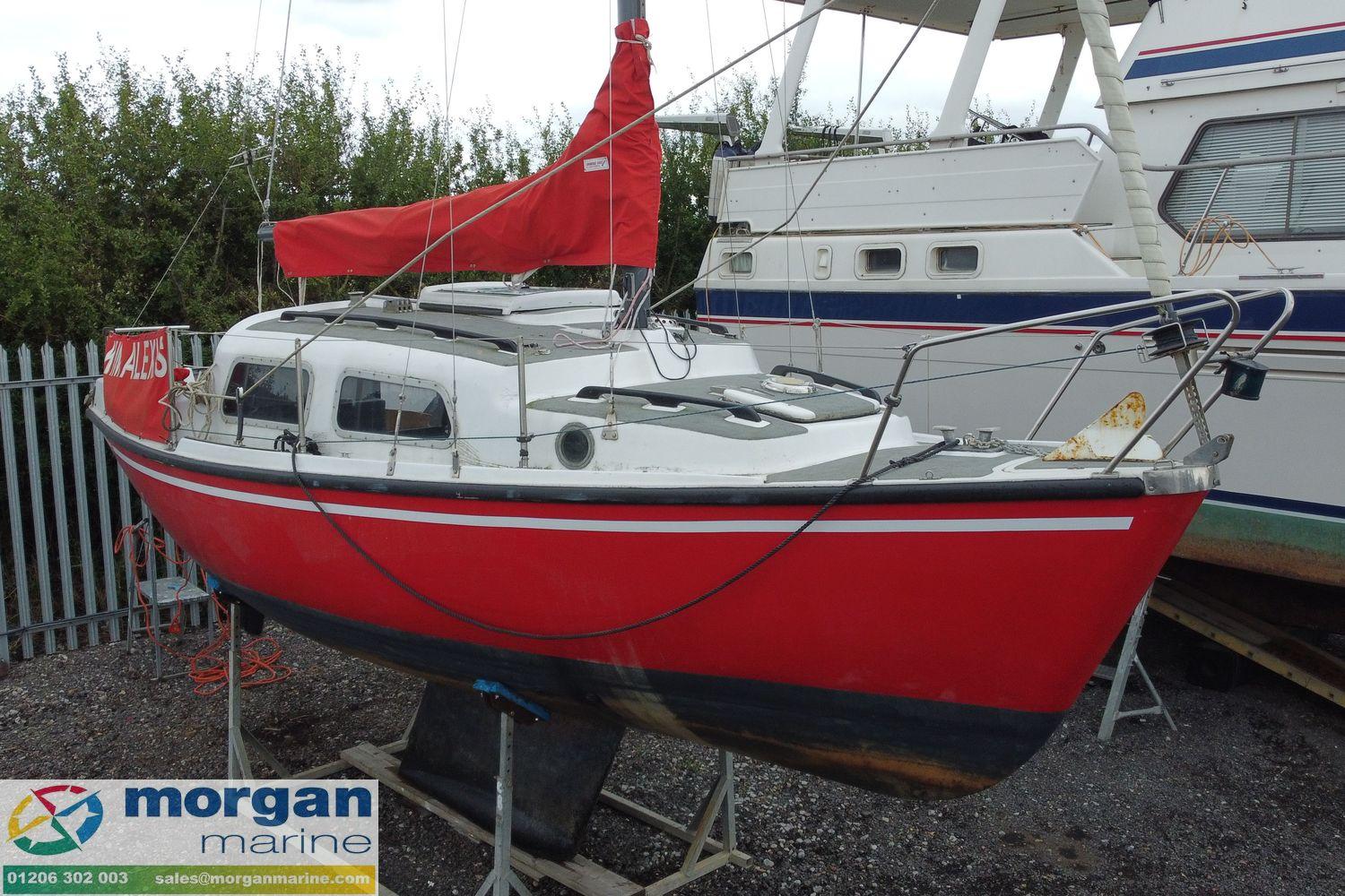 1979 Leisure 23 sailboat with red hull and white cabin, displayed at Morgan Marine.
