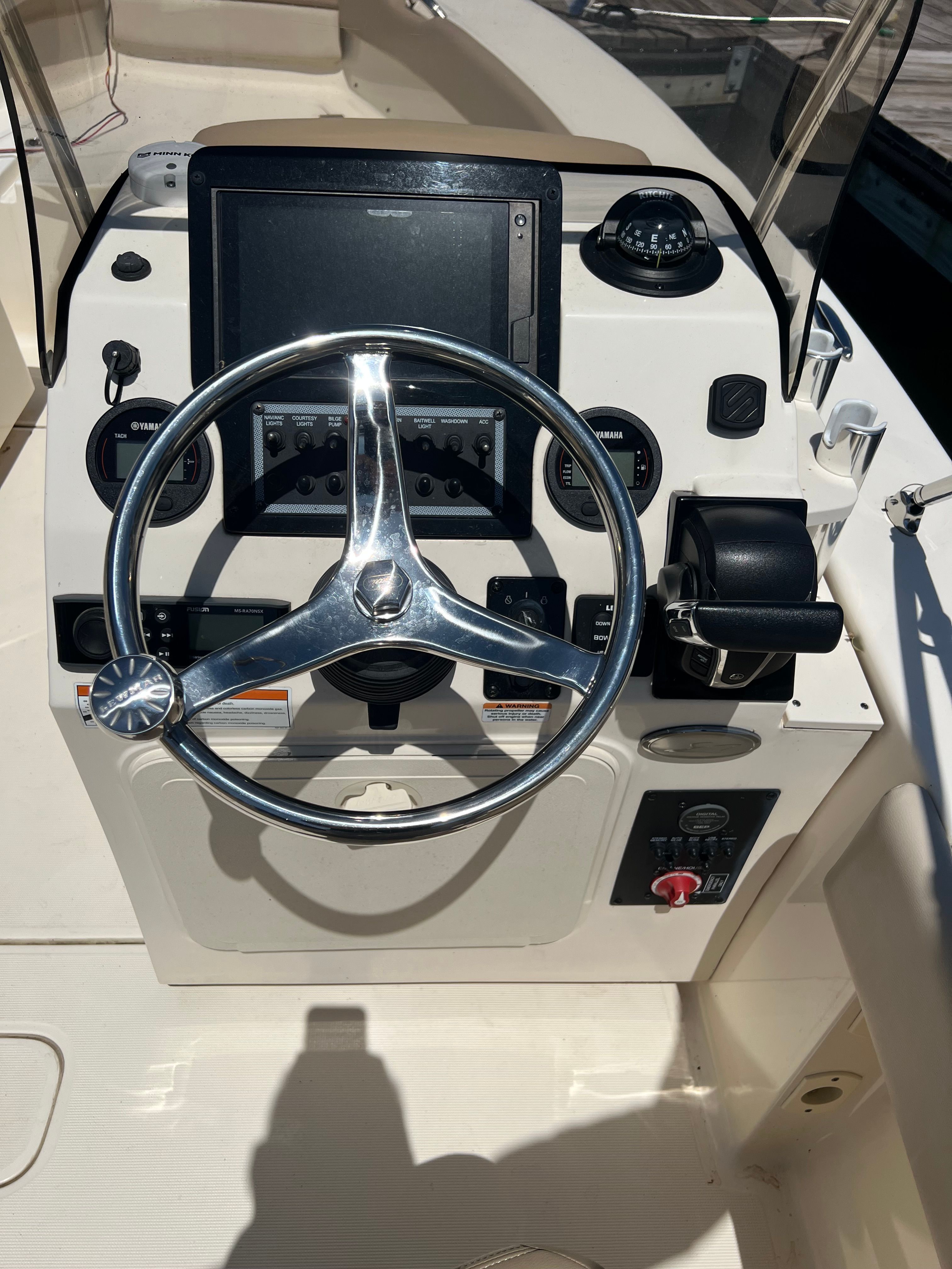Helm of a Scout 195 Sport Dorado with steering wheel and instruments.