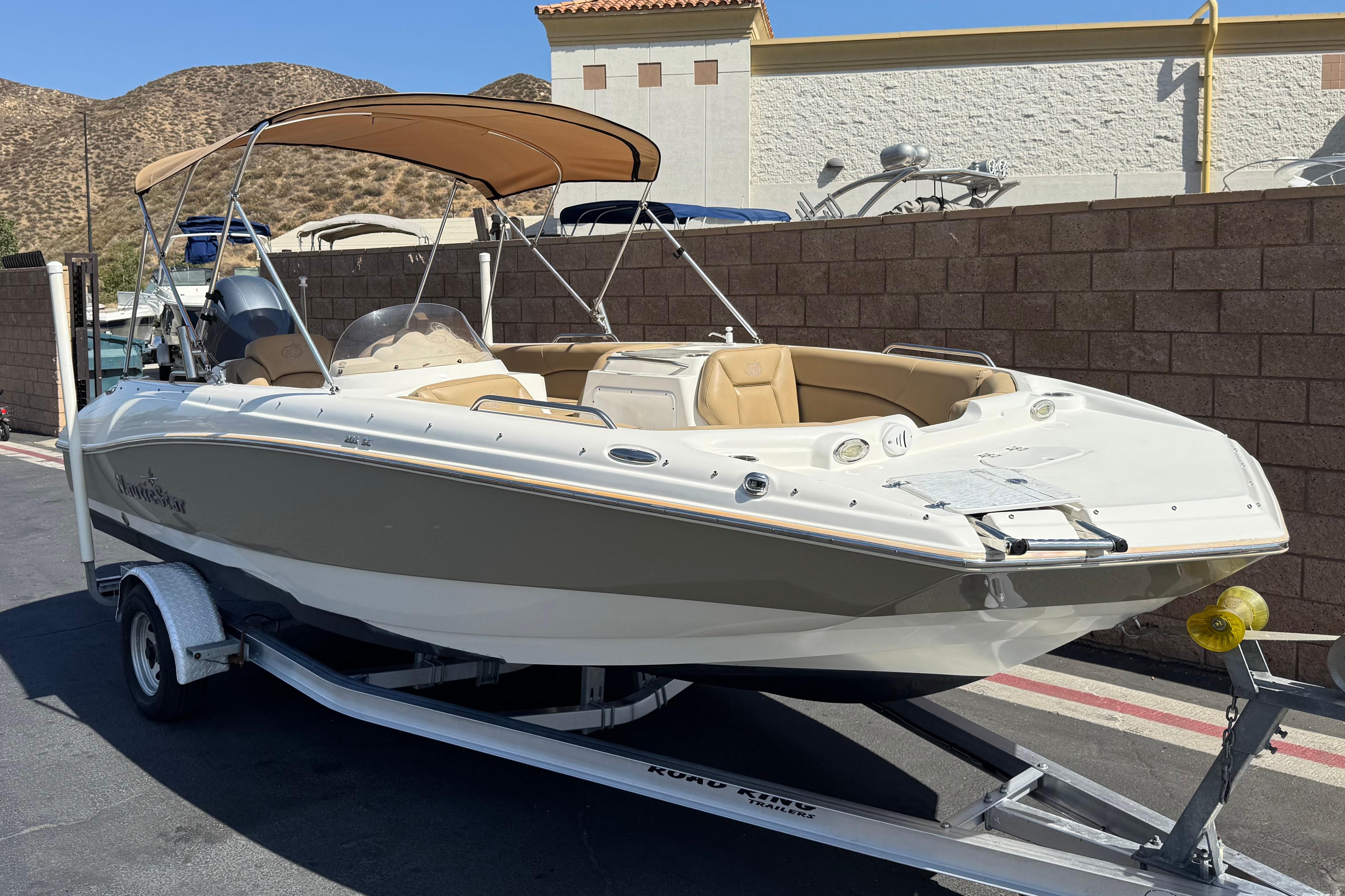2020 NauticStar 203 SC boat on trailer, beige interior, parked outdoors.