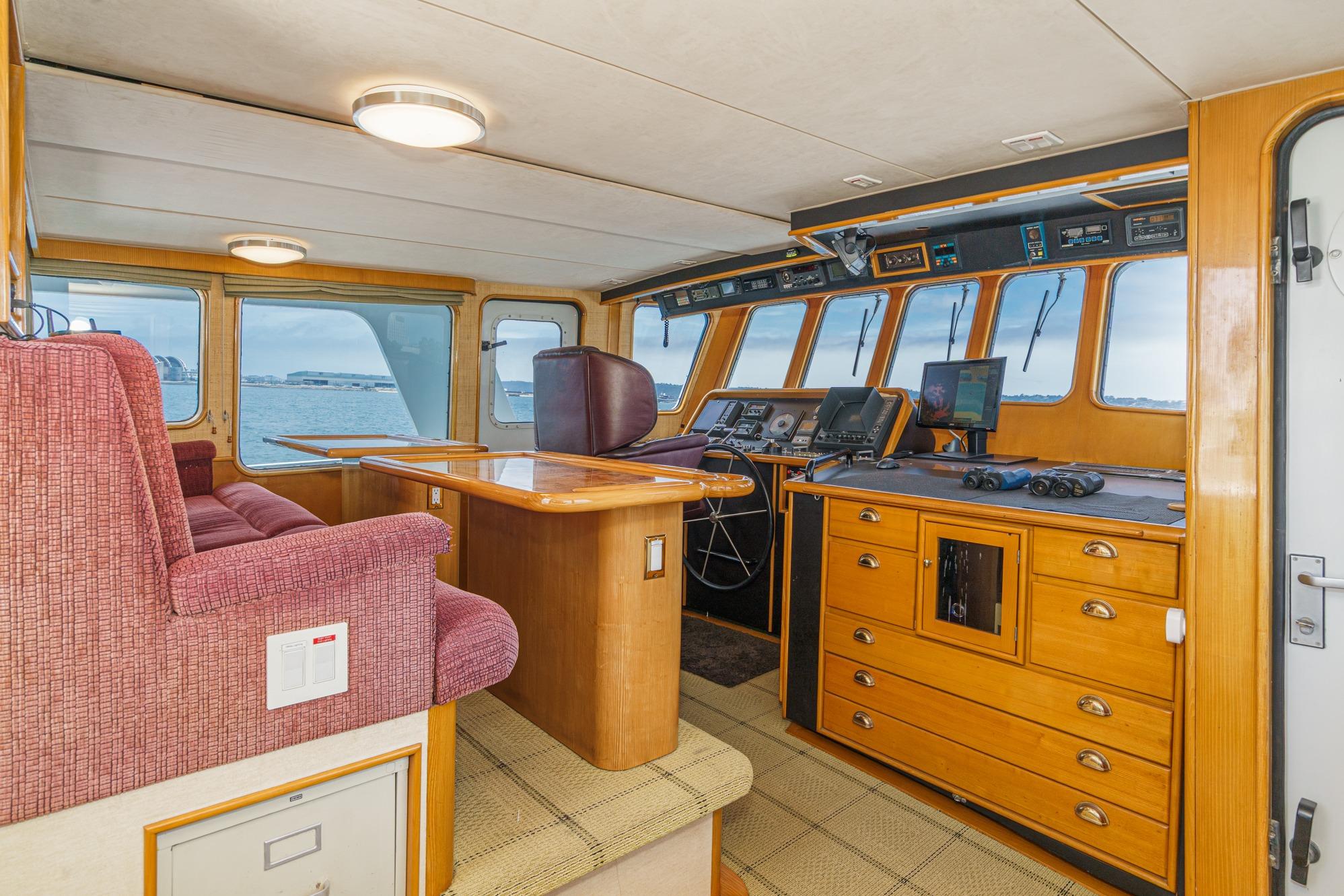 Interior of 1990 Seaton Long Range Cruiser with navigation equipment and seating.