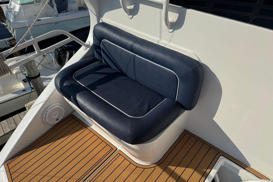 Blue cushioned seating on 2002 Viking 61 Enclosed Bridge yacht deck.