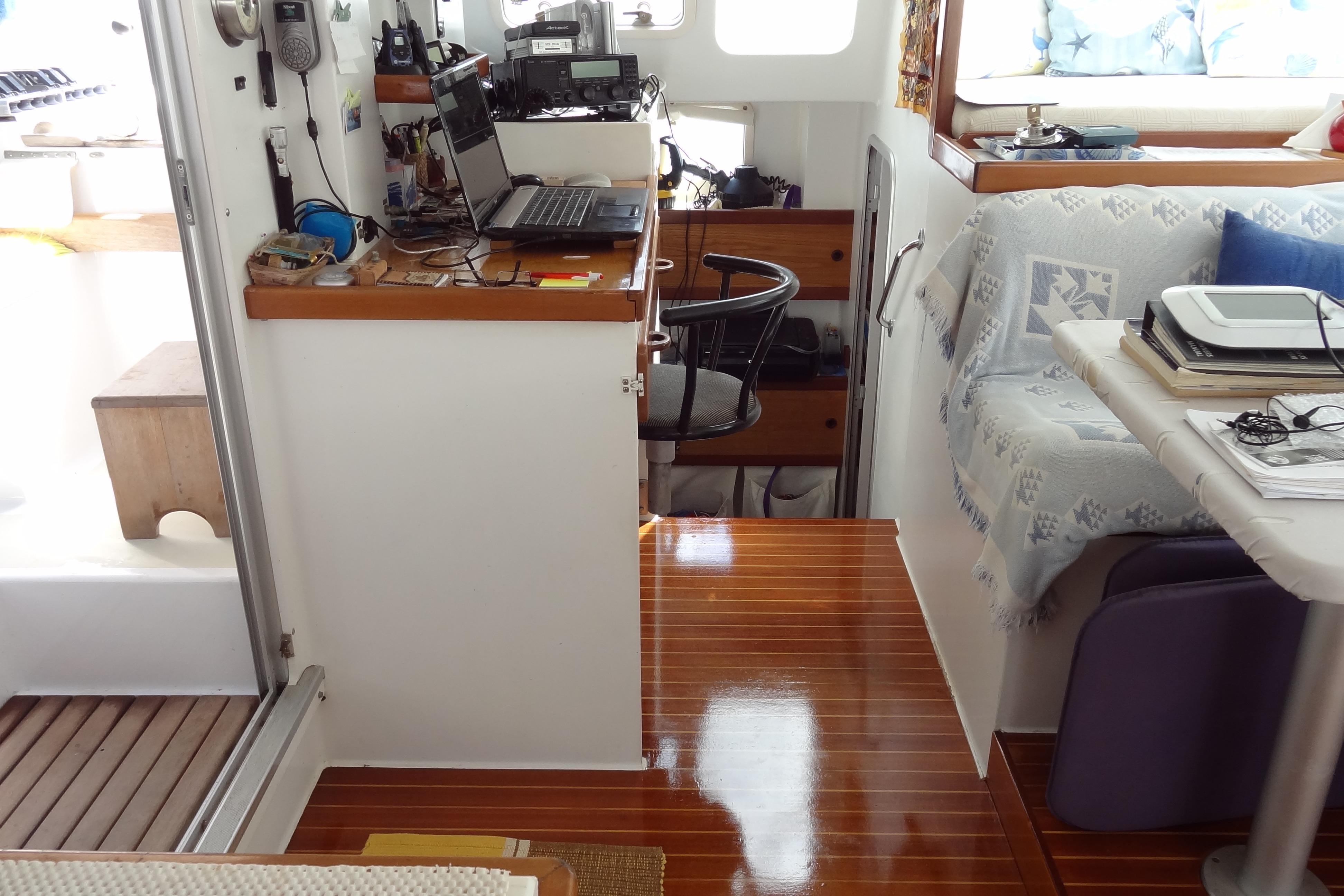 Interior of 1997 Naval Force 3 Tropic 56 yacht with wooden flooring and navigation equipment.