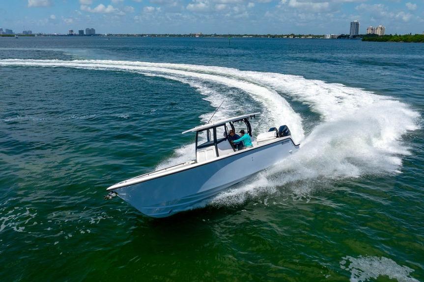 A 2027 Reef Runner 340 boat making a sharp turn on open water.