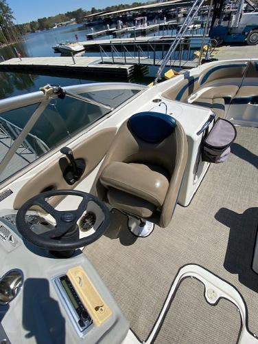 2005 Bayliner 249 SD boat interior with steering wheel and seating, docked at marina.