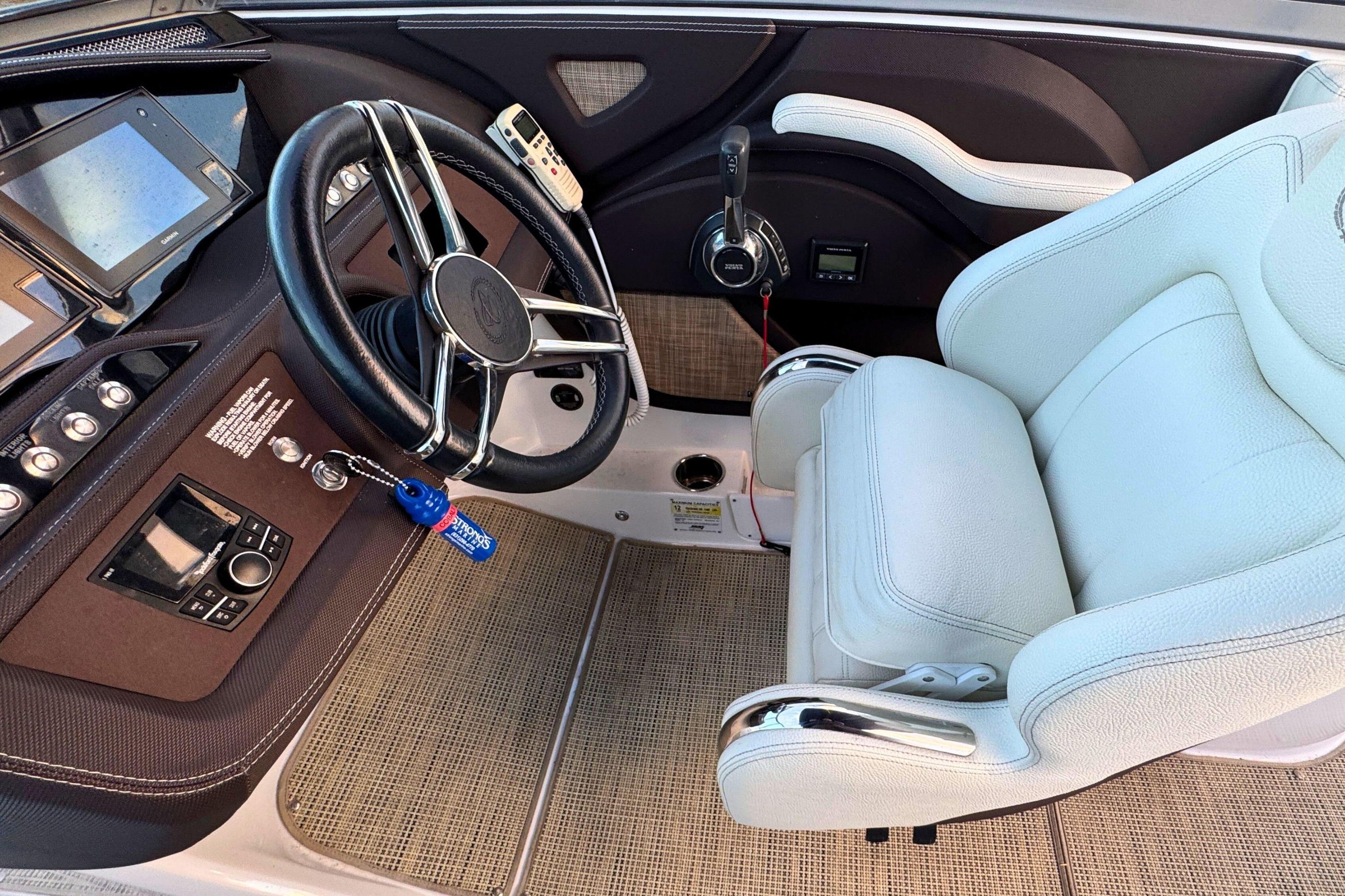 2019 Cobalt R3 boat cockpit with steering wheel and white captain's chair.