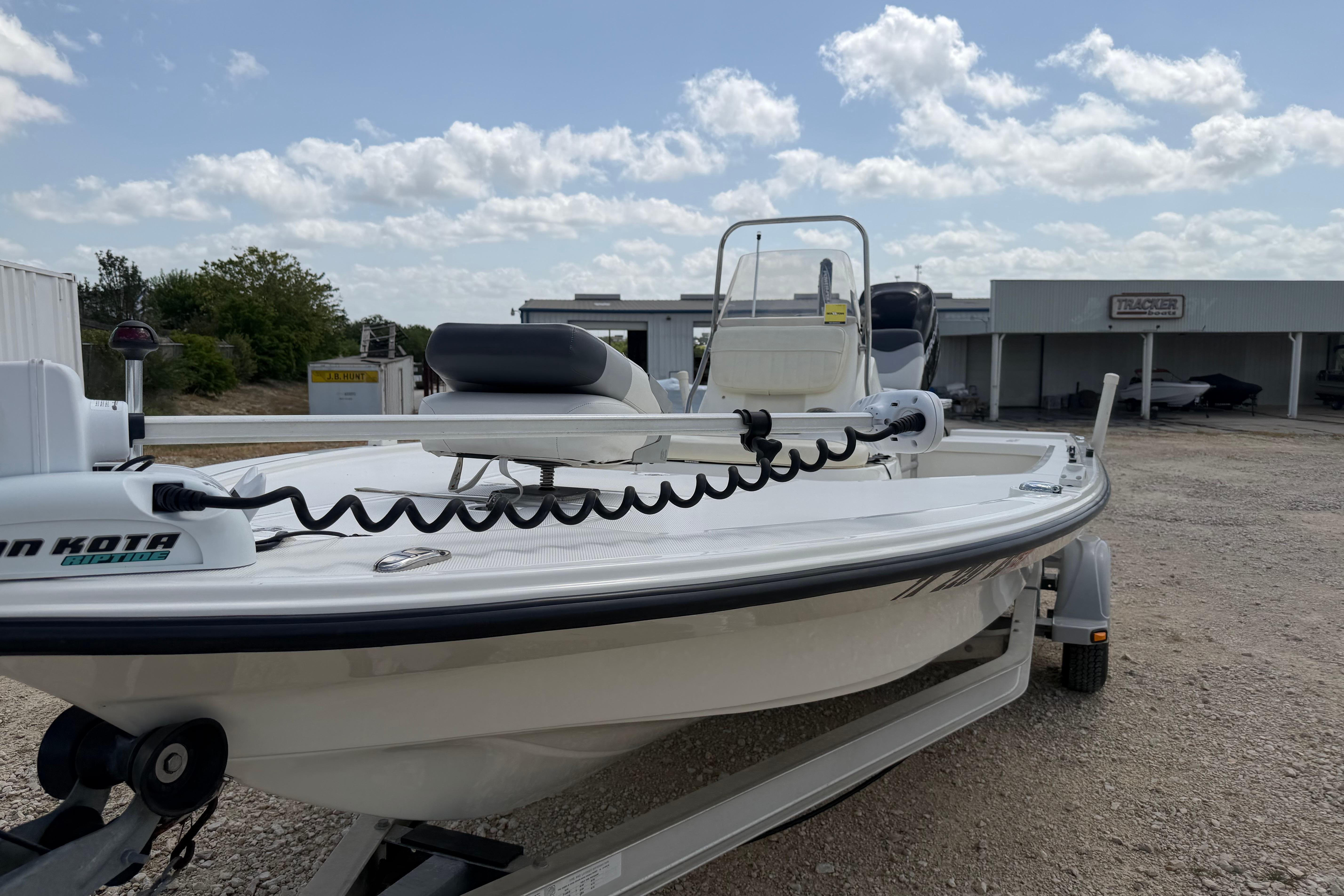 2012 Mako 18 LTS boat on trailer, featuring Minn Kota trolling motor, under a partly cloudy sky.