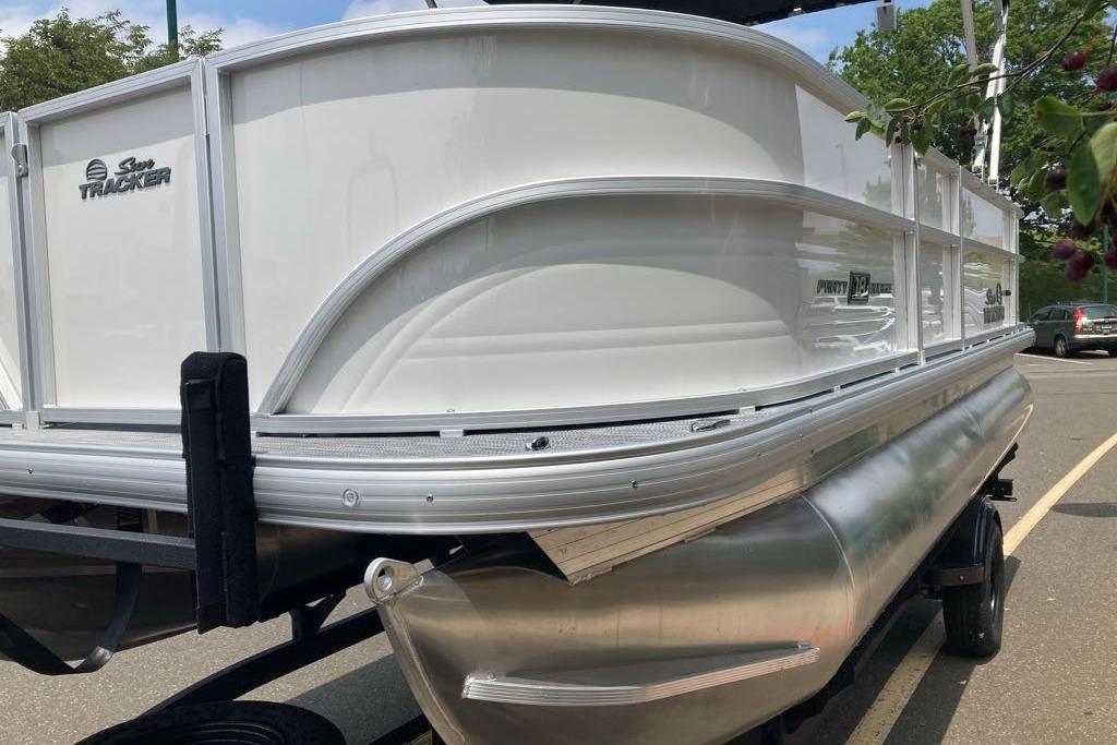 2026 Sun Tracker Party Barge 18 DLX pontoon boat on trailer, side view.