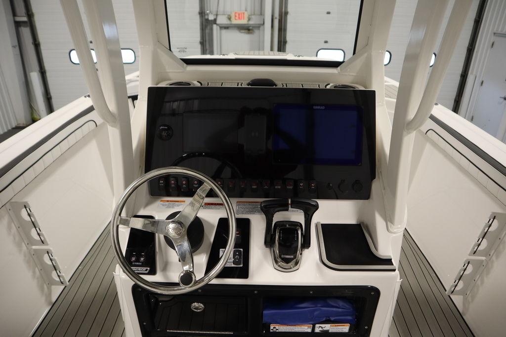 Yamaha Boats 2026 255 FSH Sport E helm with steering wheel and control panel.