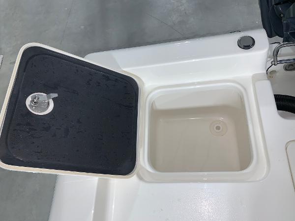 Key West 188 Bay Reef 2026 boat compartment with open lid, showcasing storage space.