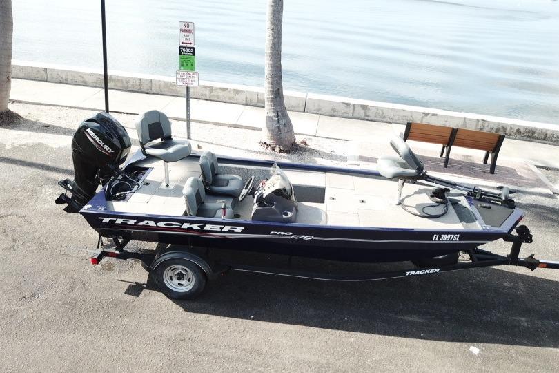 2020 Tracker Pro 170 boat on trailer by waterfront, no parking sign visible.