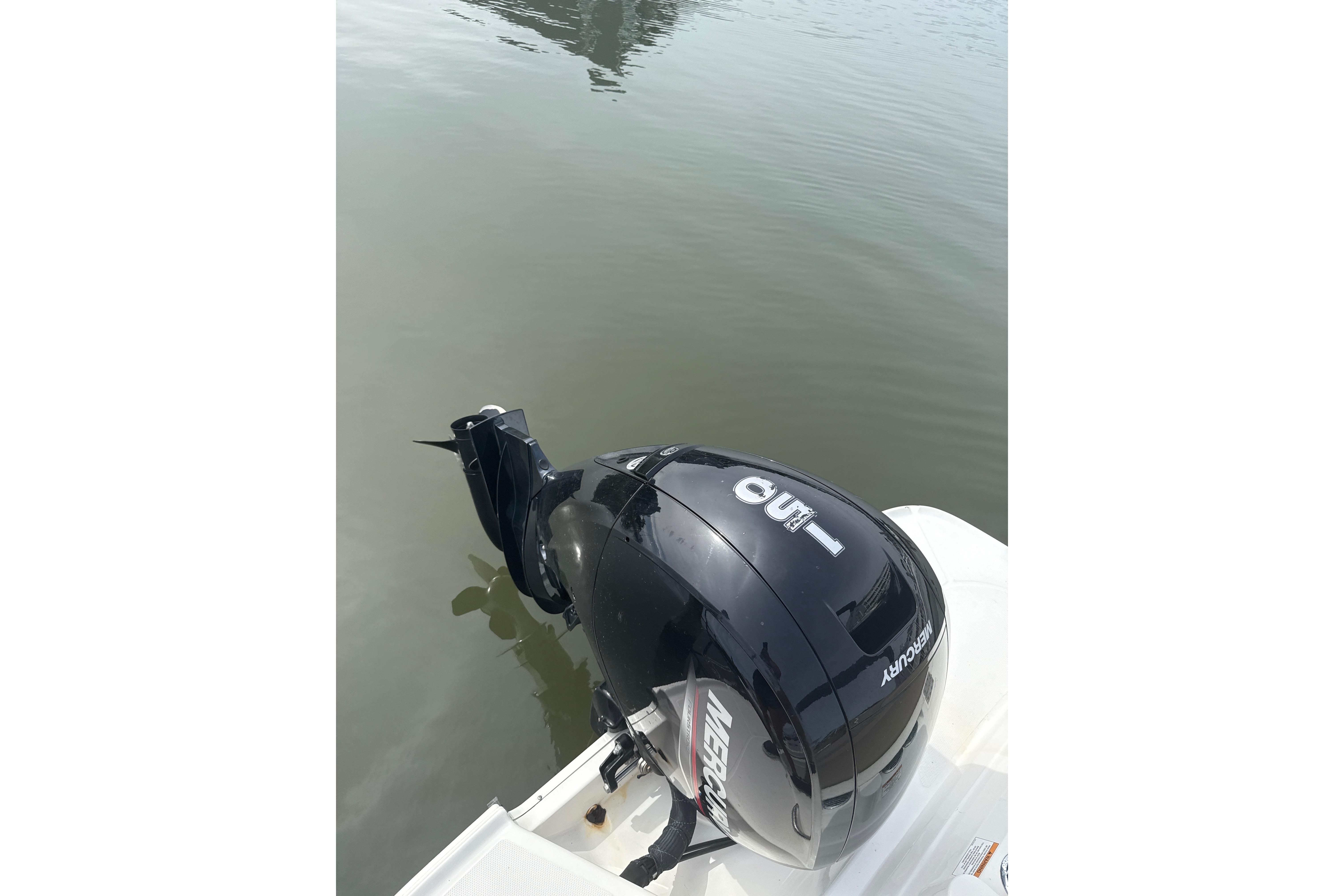 2025 Bayliner VR6 Bowrider OB with Mercury outboard engine on calm water.