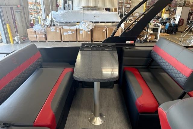 Luxurious interior of 2027 Godfrey Monaco 25' Tritoon with mid-table flip lounge seating.