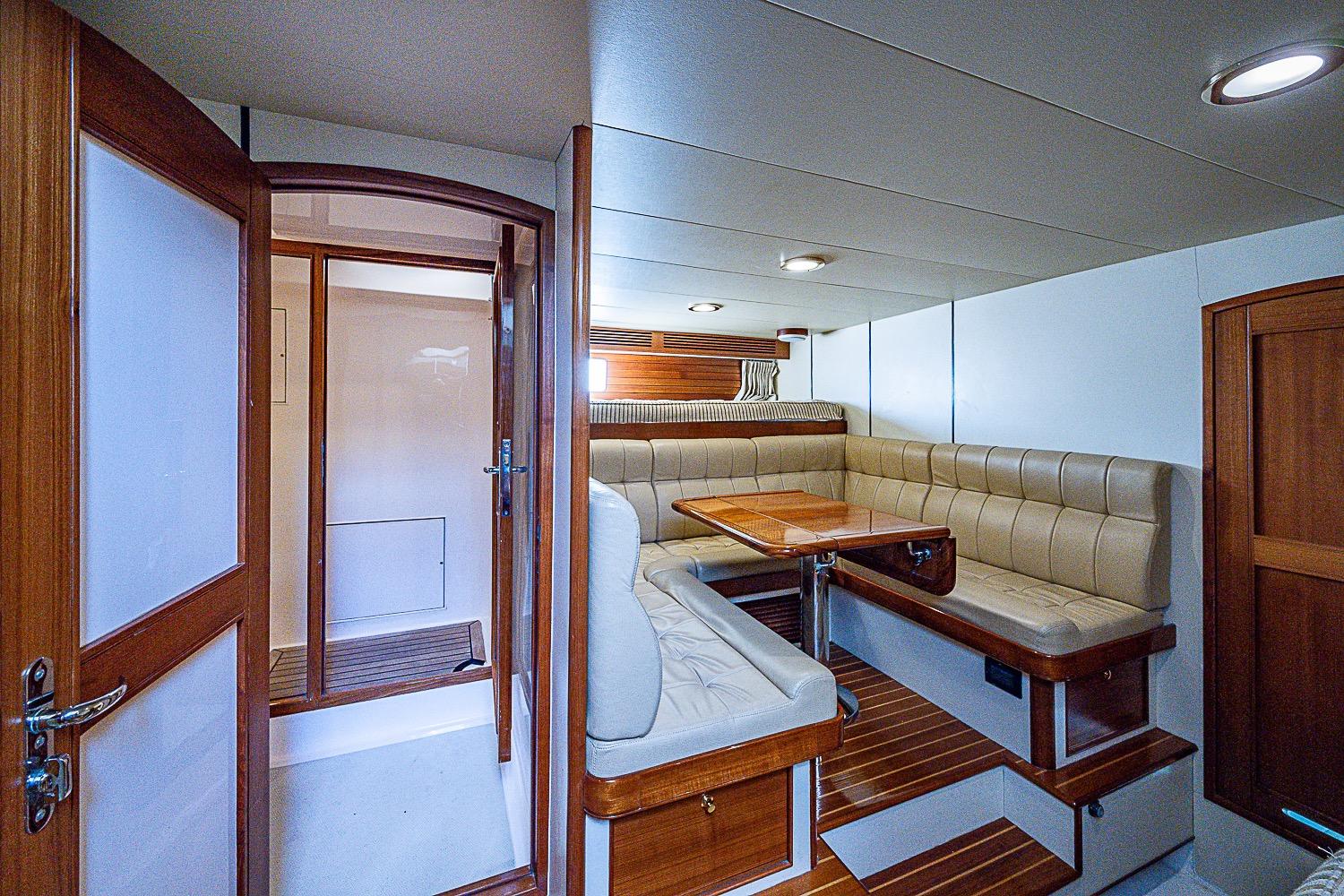 Luxurious interior of 2014 Marlow 80 Explorer yacht with elegant seating and wooden finishes.