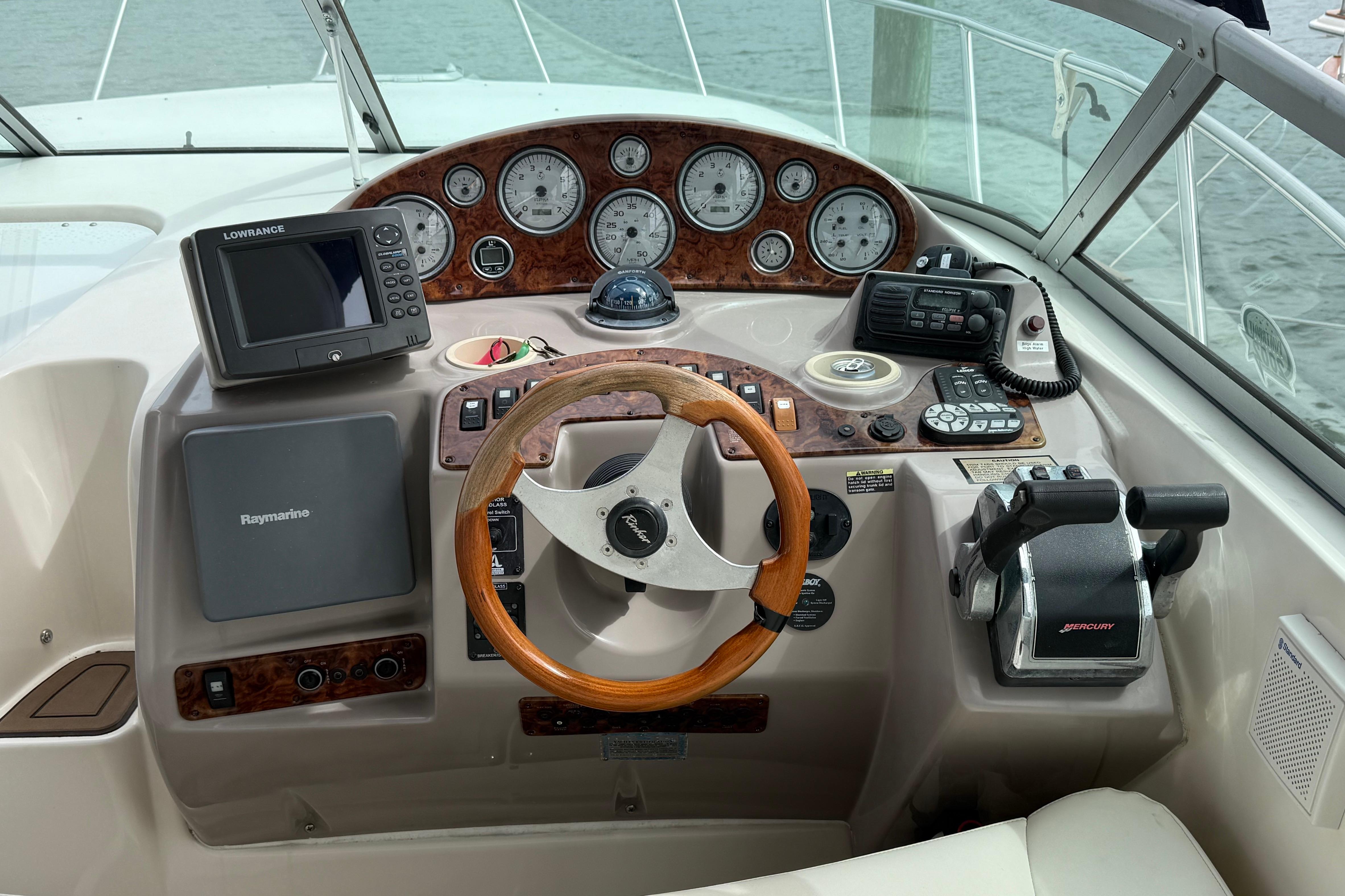 2004 Rinker 342 boat dashboard with steering wheel and navigation instruments.