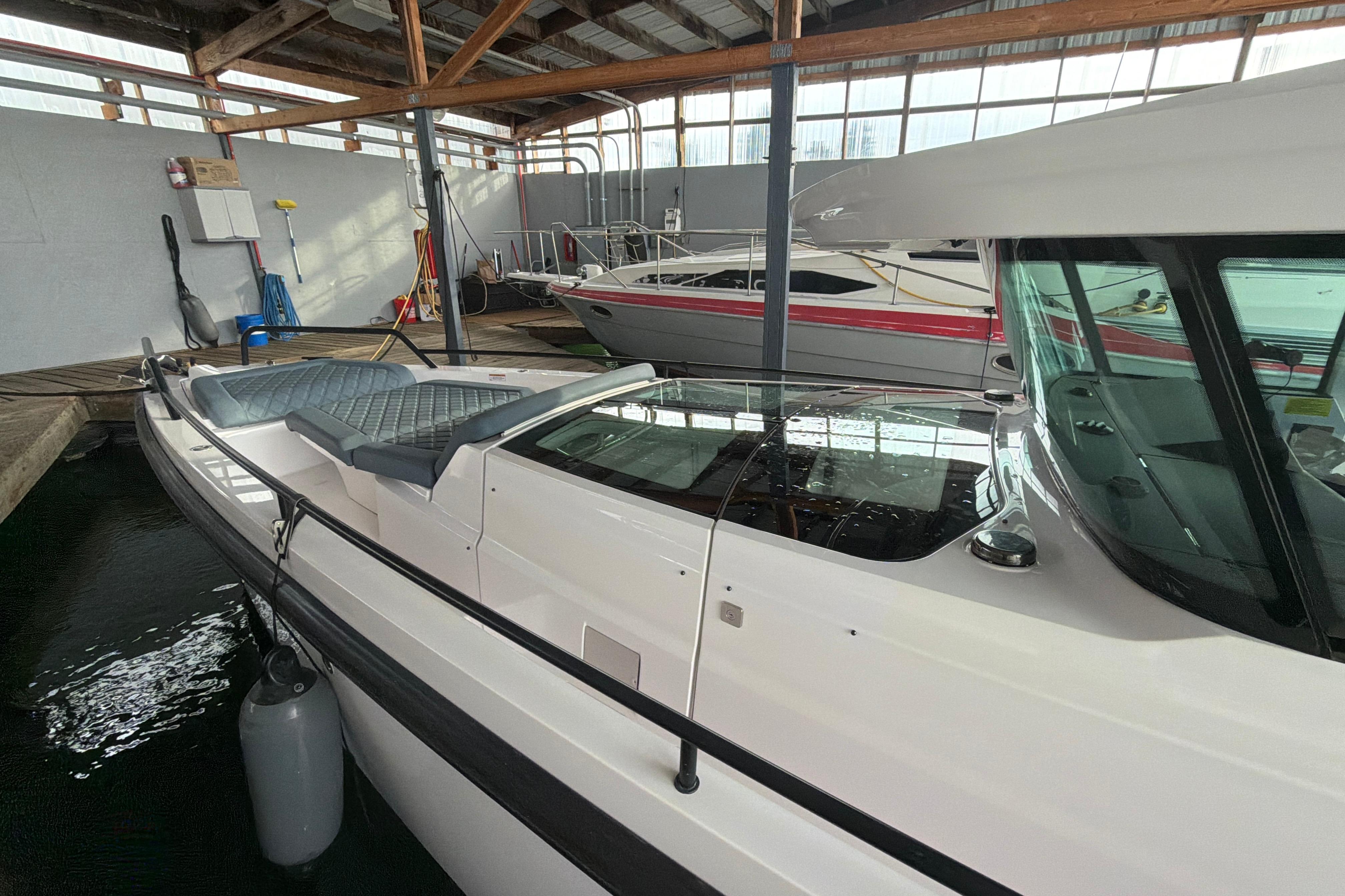 2022 Axopar Brabus 37 XC Cross Cabin boat docked in a marina, showcasing sleek design.