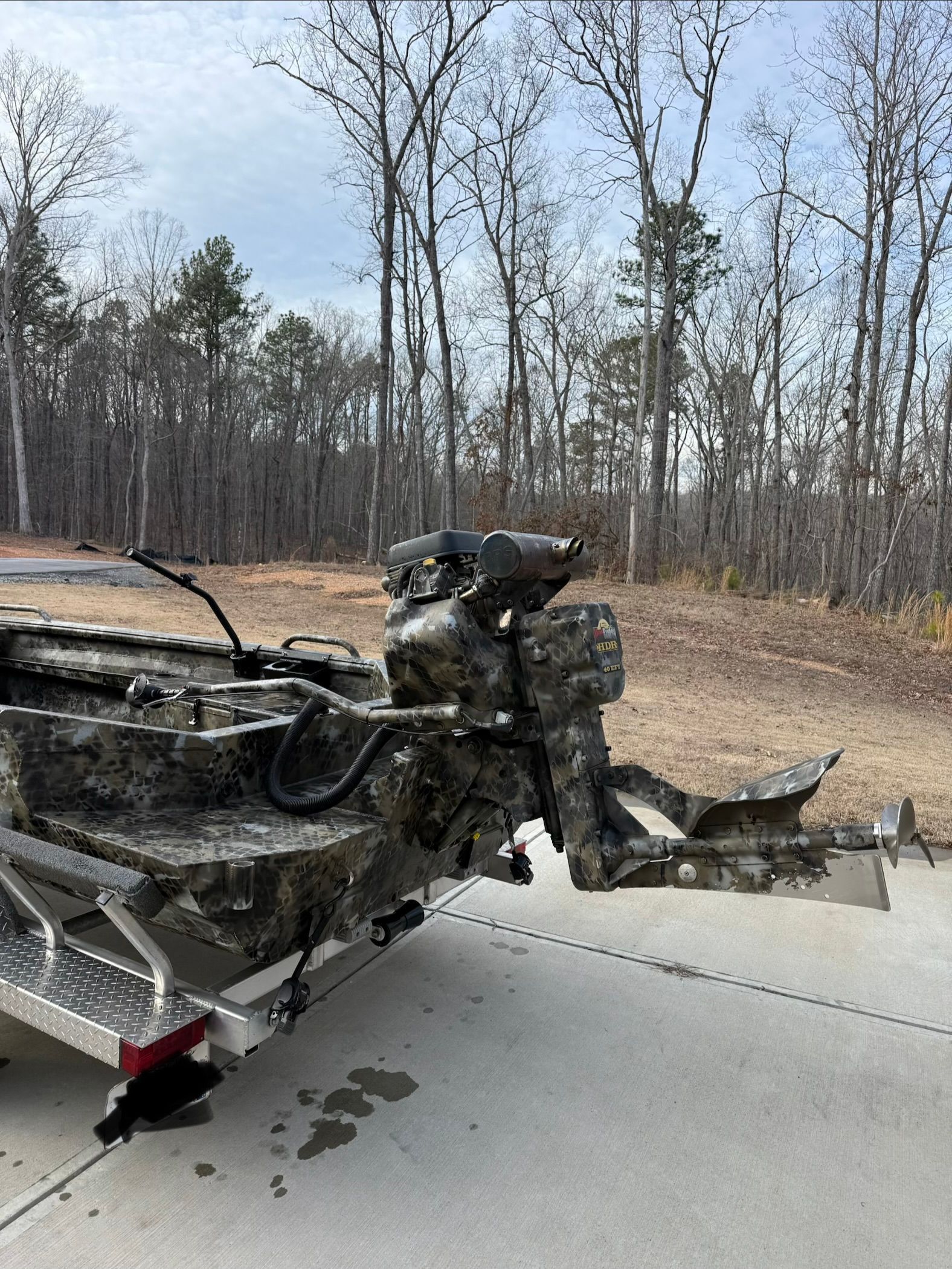 2024 Excel 1754 Shallow Water F4 boat on trailer in forest.