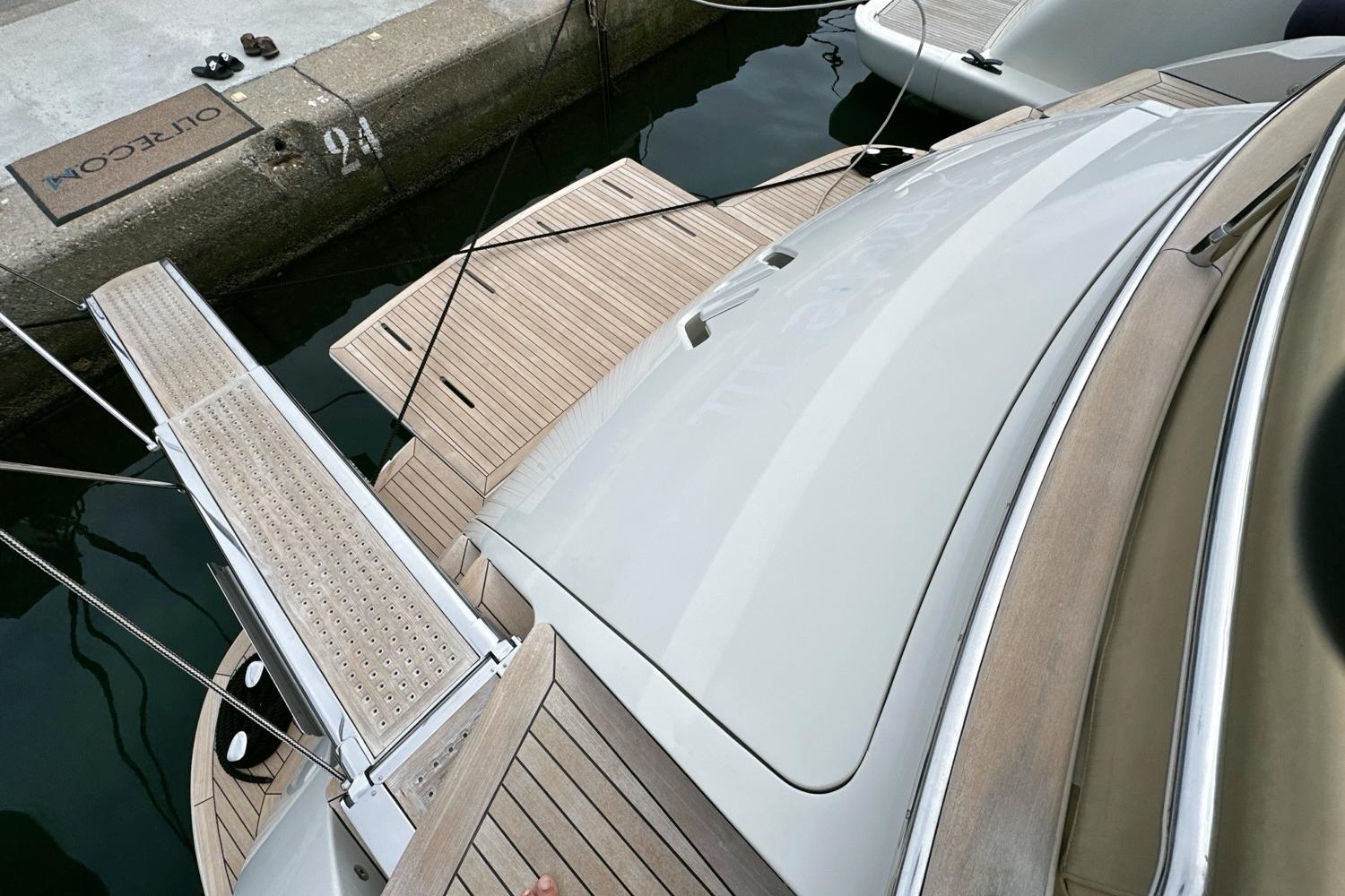 2010 Abati Yachts 64 Freeport docked, showcasing sleek design and wooden deck details.