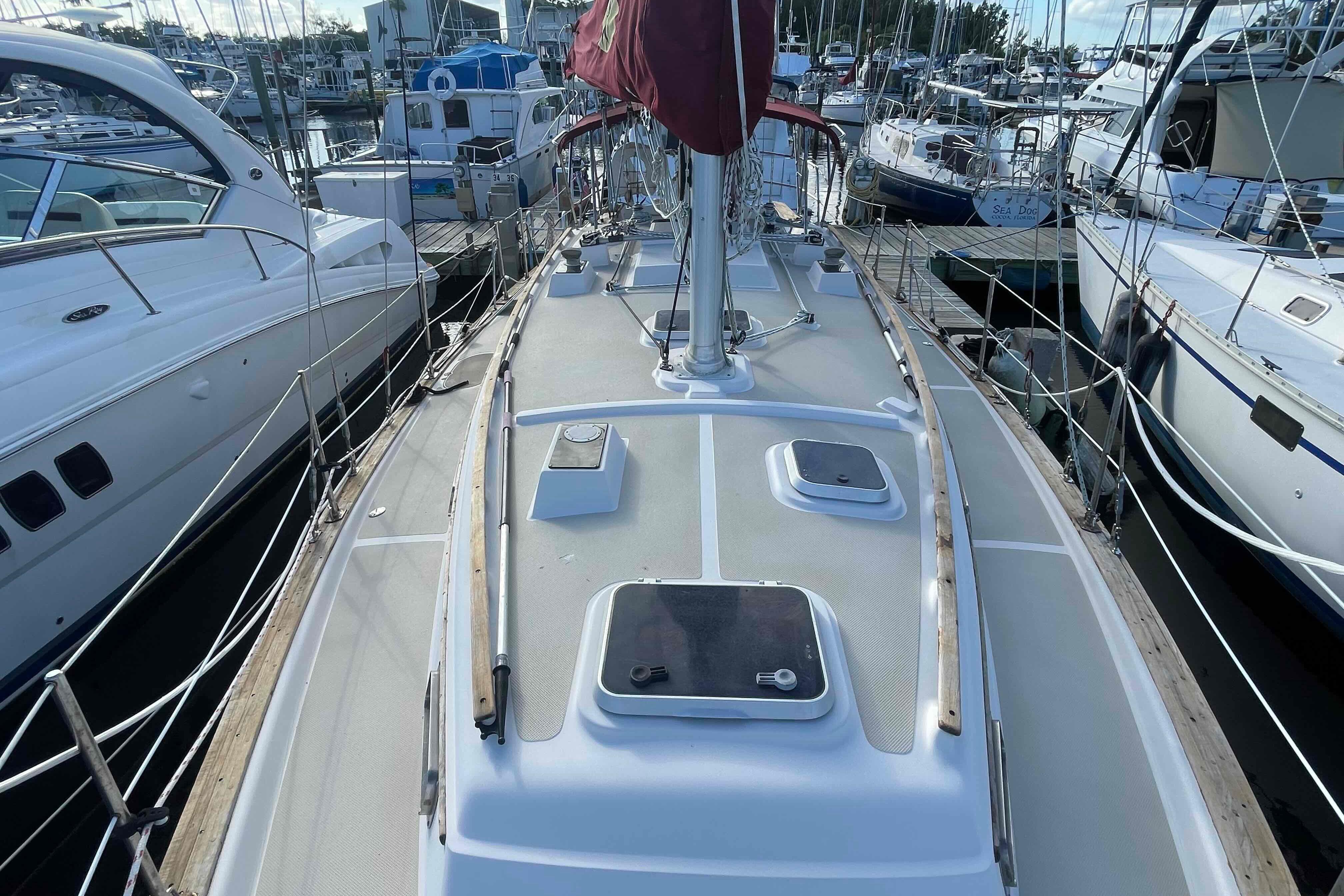 1989 Island Packet 35 sailboat docked at marina, view of deck and mast.