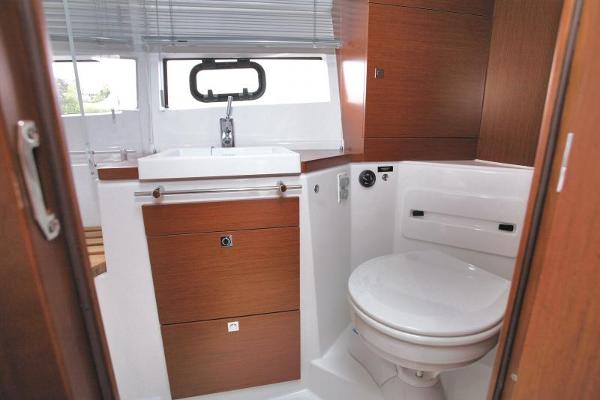 2017 Jeanneau NC 11 boat bathroom with sink and toilet.