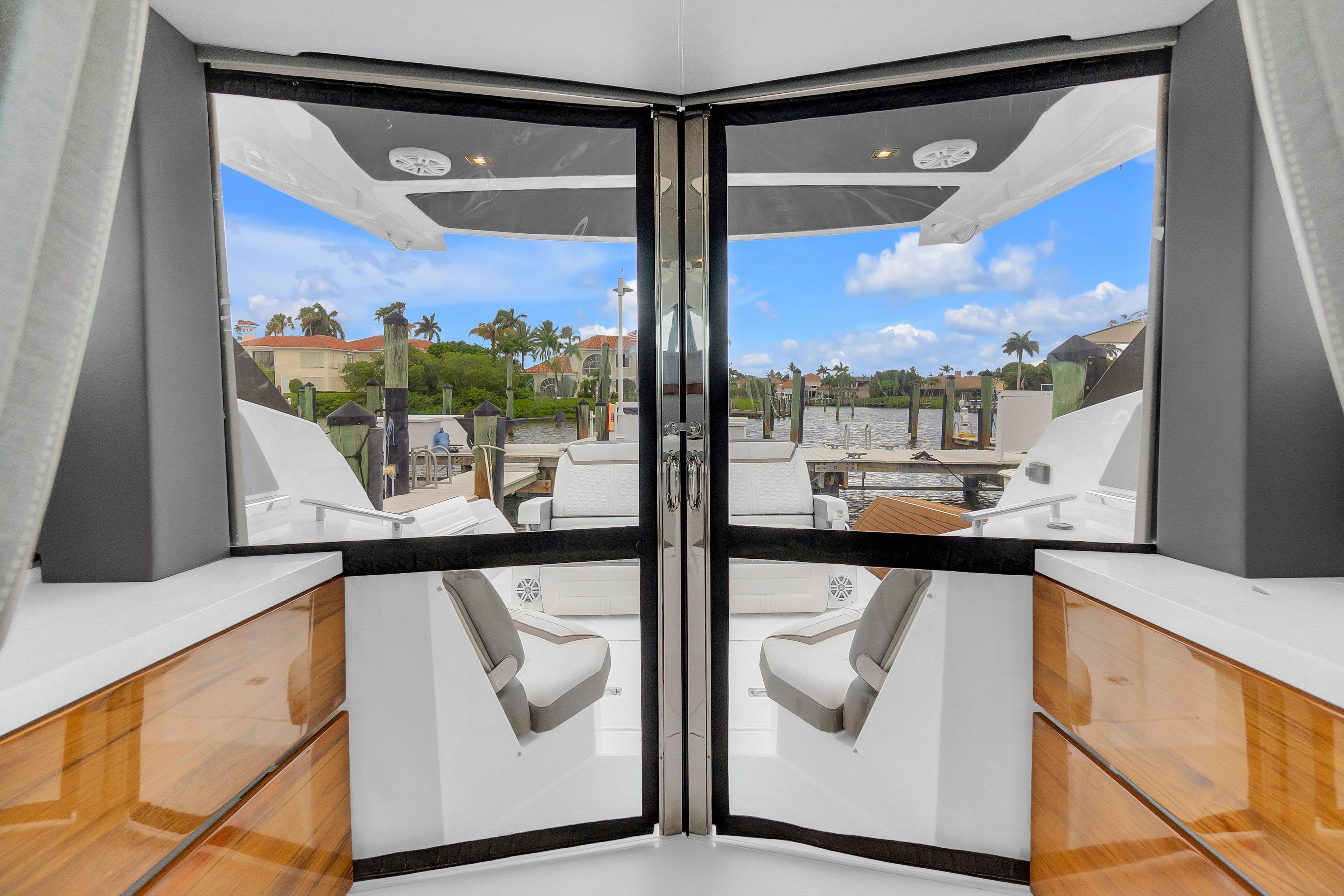 Interior view of 2021 Tiara Sport 43 LE yacht with open doors to deck.
