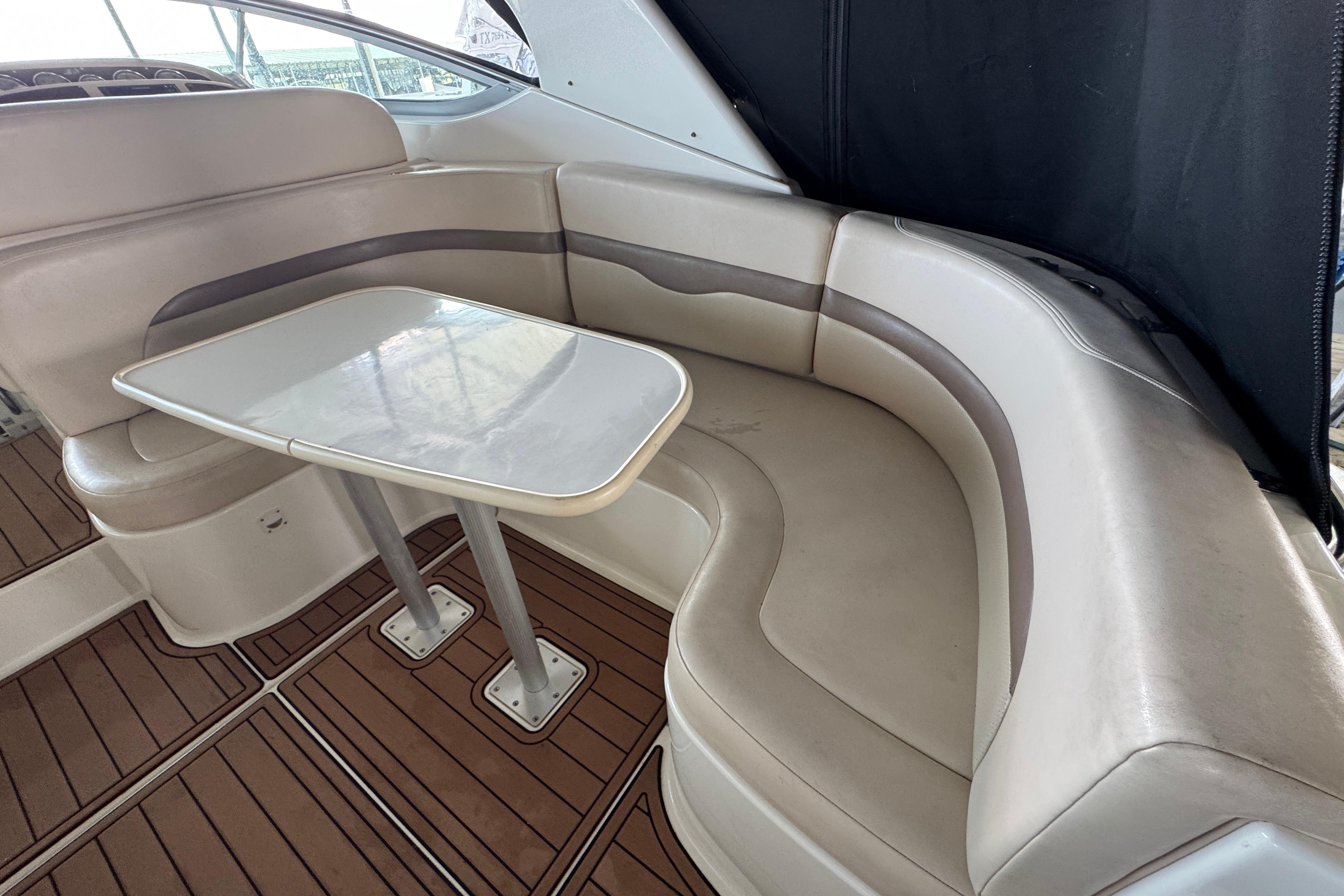 2006 Chaparral 330 Signature boat interior with curved seating and table.
