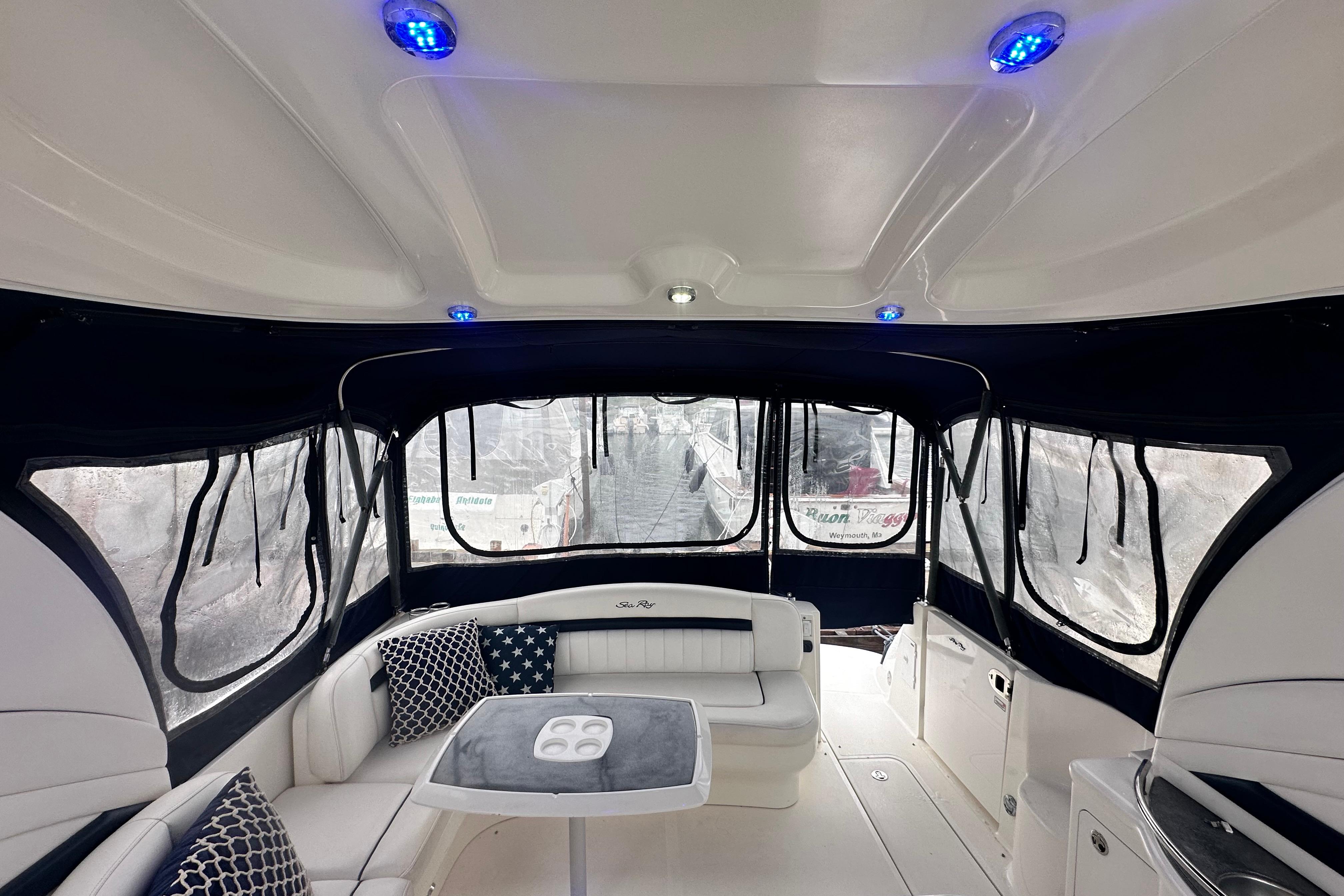 Interior of 2005 Sea Ray 390 Sundancer yacht with seating and blue LED lights.