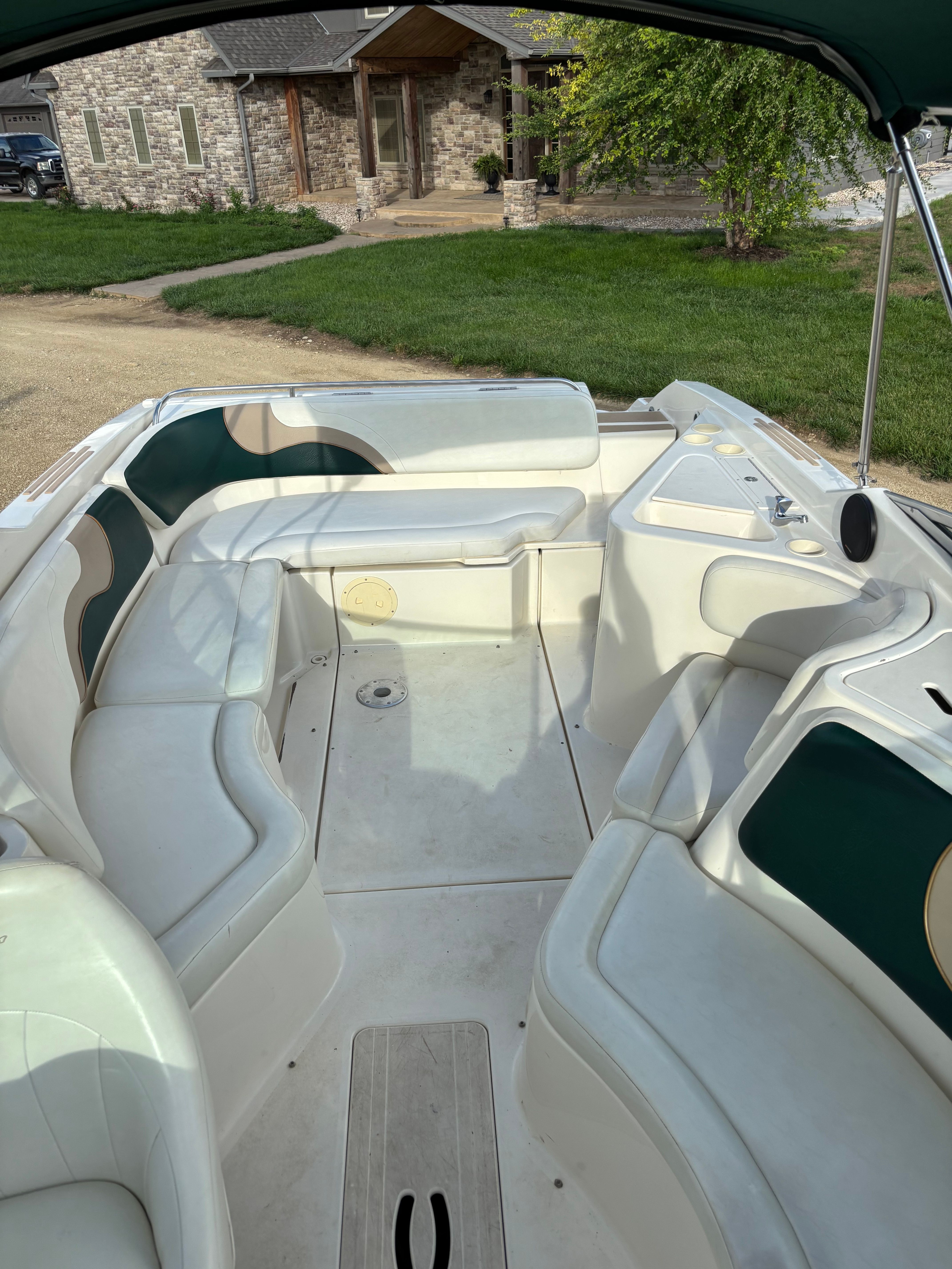 Interior of a 1999 Rinker Captiva 272 boat, parked in a yard.