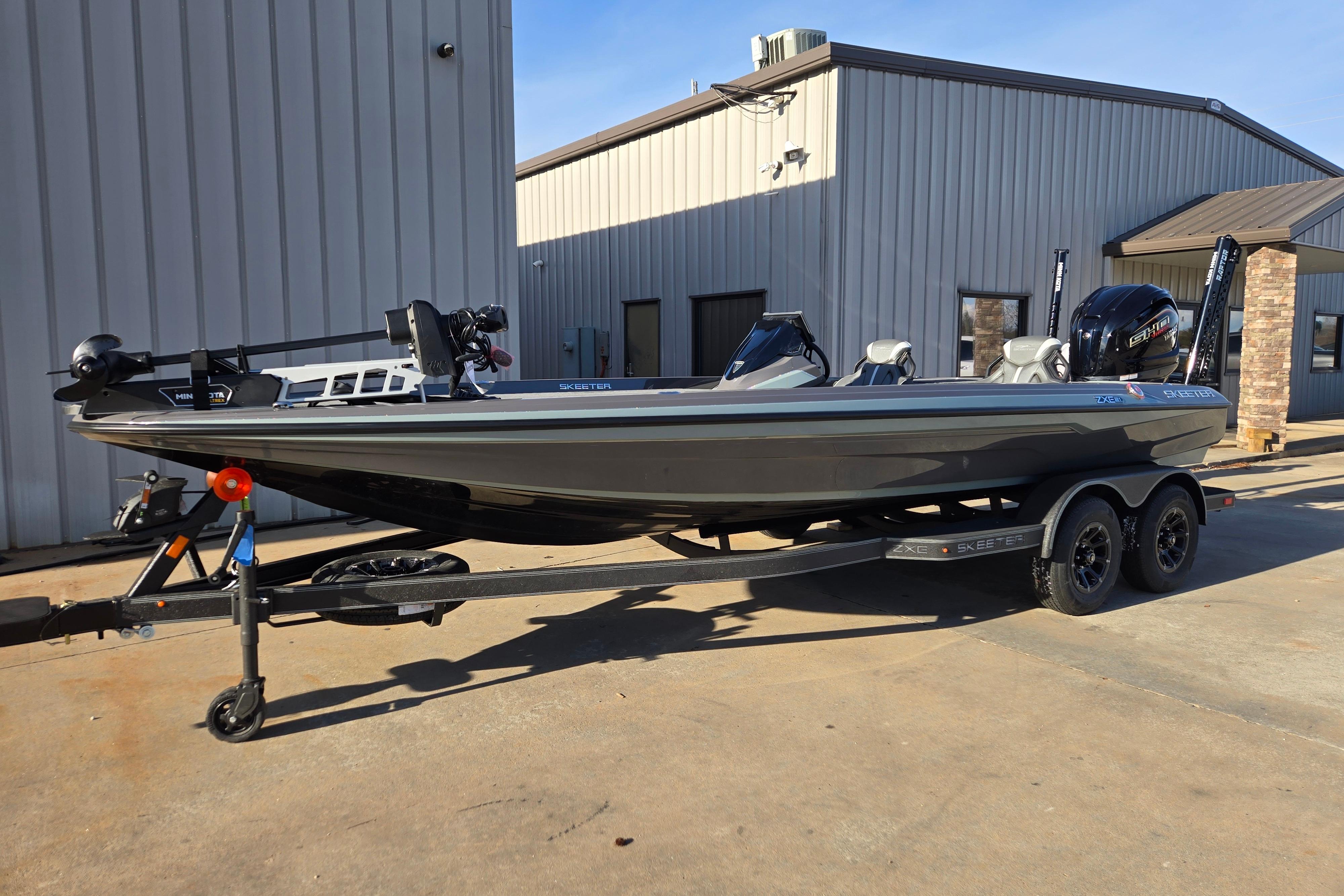 2026 Skeeter ZXE21 boat on trailer, parked outside a building.
