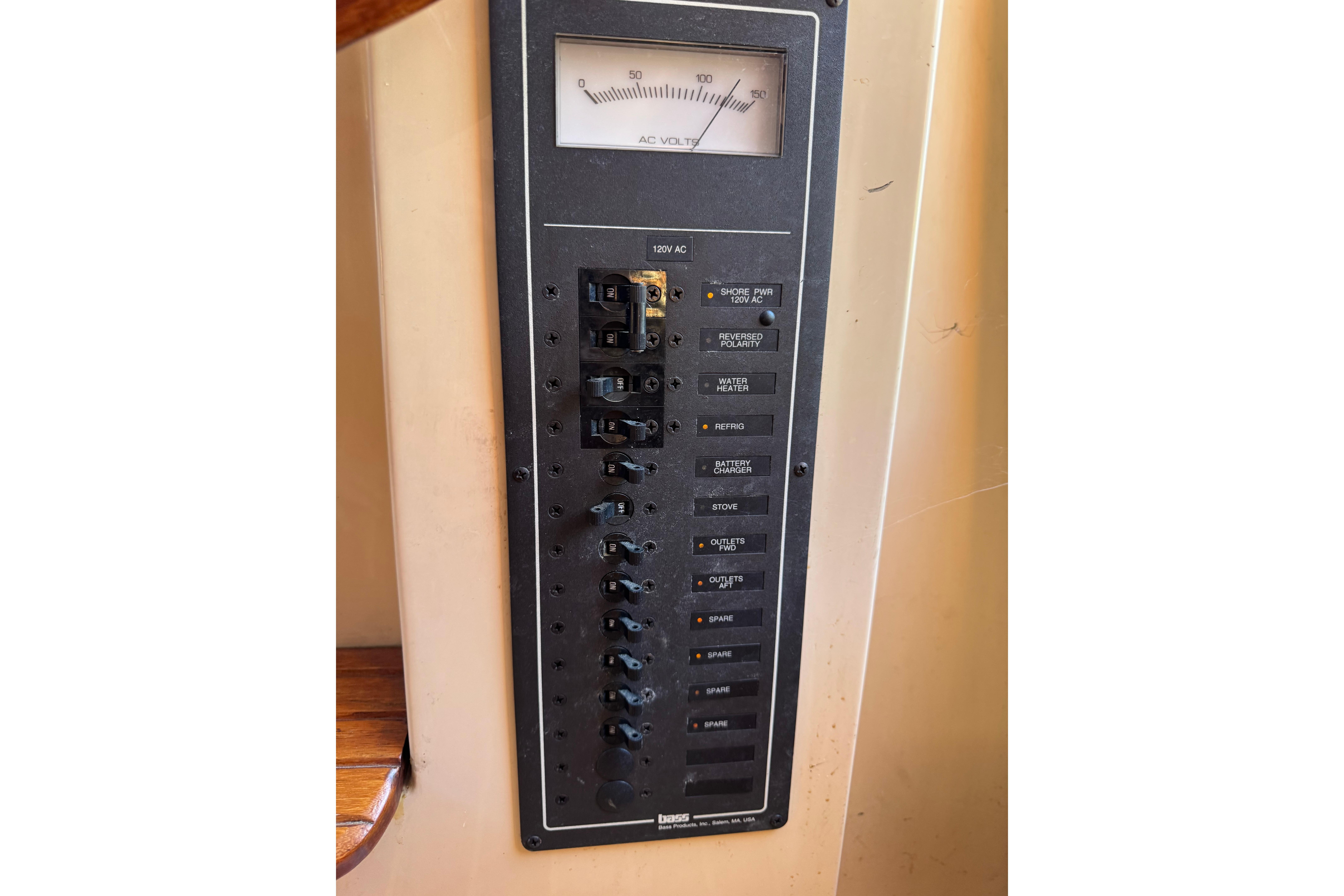 Electrical panel on a 1996 Nordic Tug 32 boat, featuring AC voltage meter and switches.