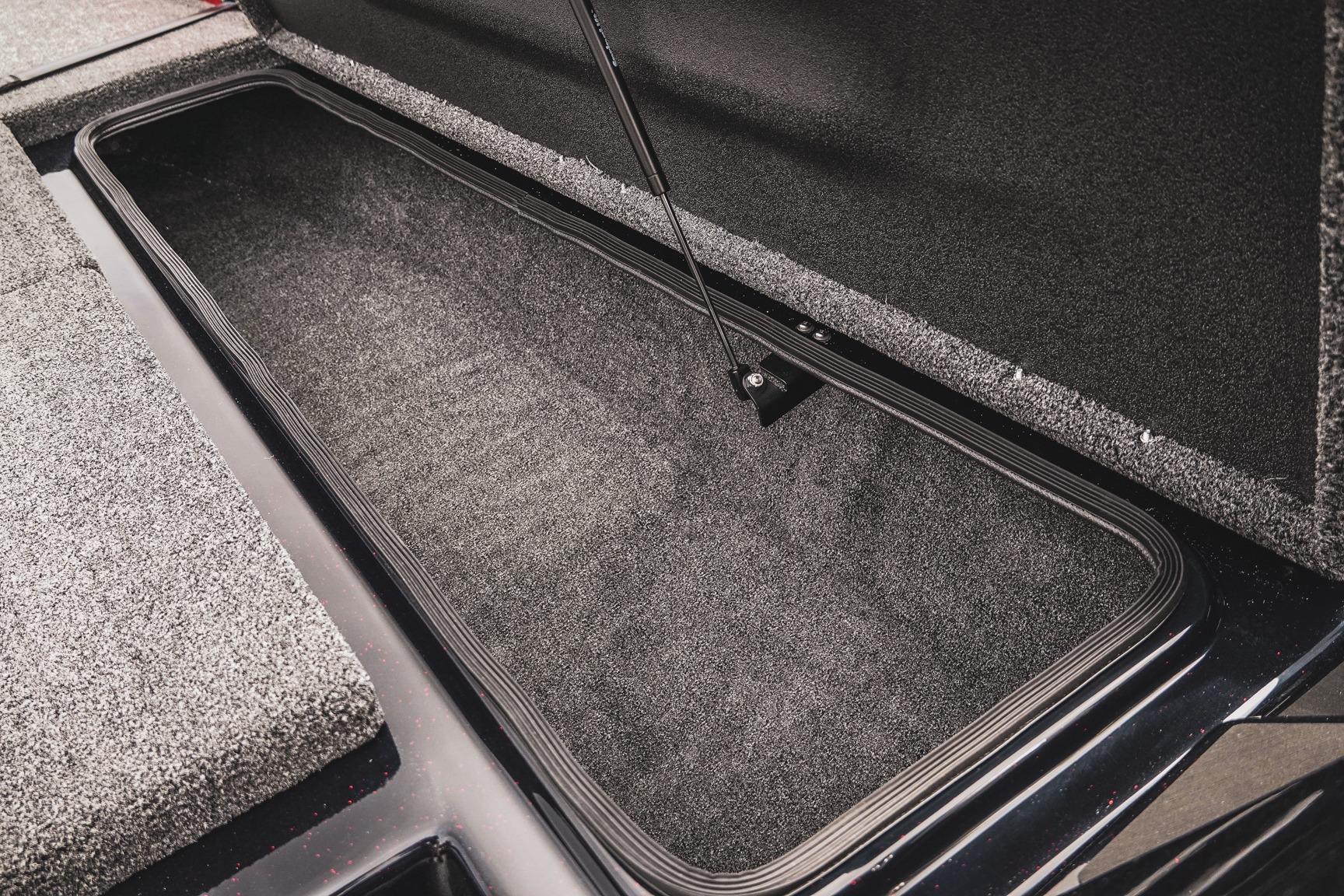 Open storage compartment in 2026 Bass Cat Cougar FTD boat, showcasing spacious interior.