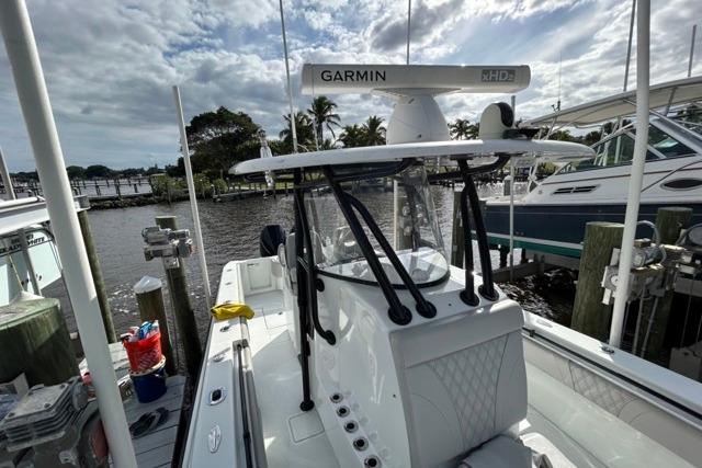 2023 Contender 32 ST boat docked, featuring Garmin radar, under a cloudy sky.