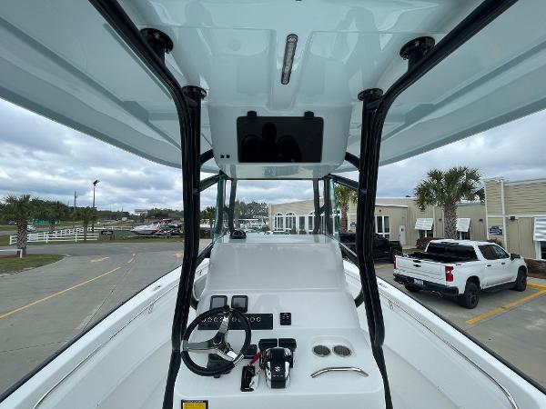2026 Cape Horn 24XS boat console with steering wheel and controls, parked outdoors.