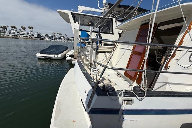 1982 Lancer 45 Motorsailer docked in a marina with nearby boats.