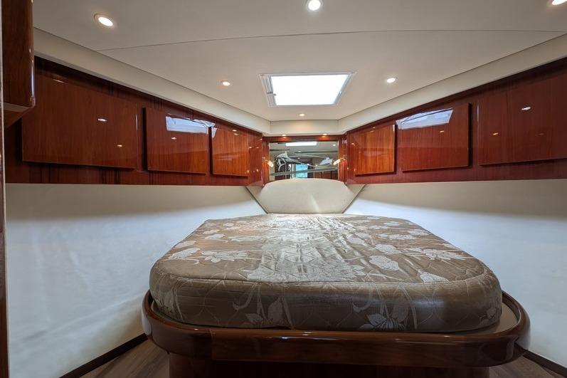 Luxurious cabin interior of 2005 Egg Harbor 43 SportYacht with elegant wood finishes.