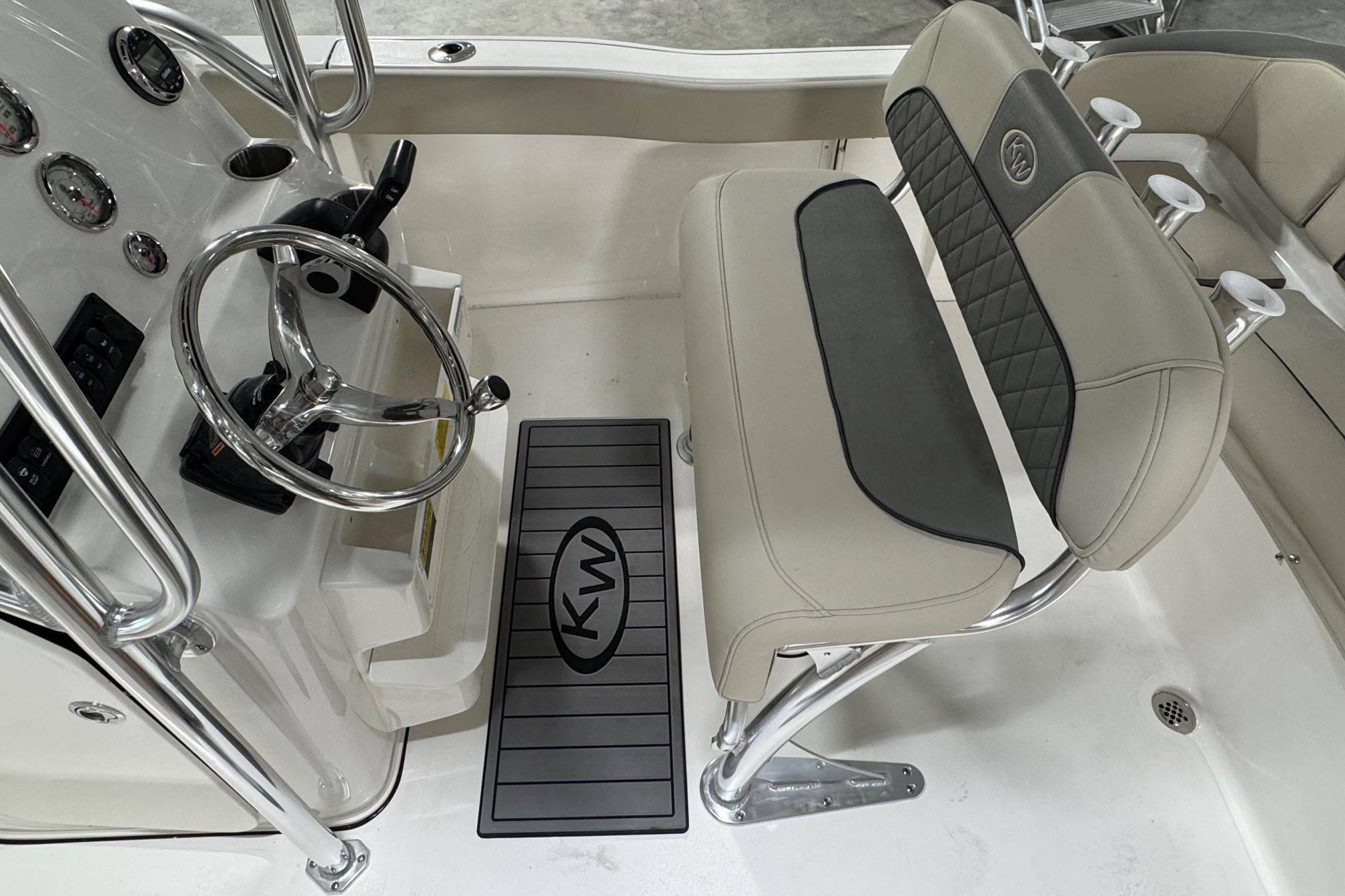 Interior of 2026 Key West 203 FS boat, featuring steering wheel and cushioned seating.