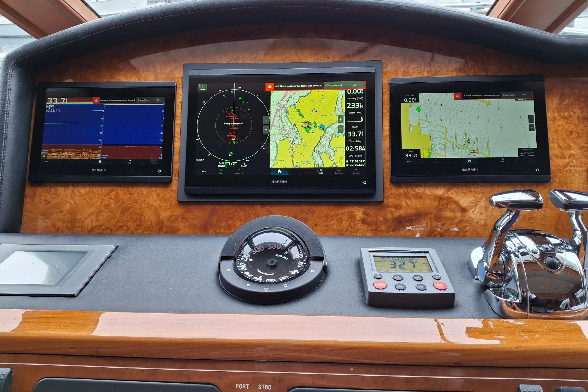 Dashboard of a 2004 Ocean Alexander 64 Pilothouse with Garmin navigation displays.