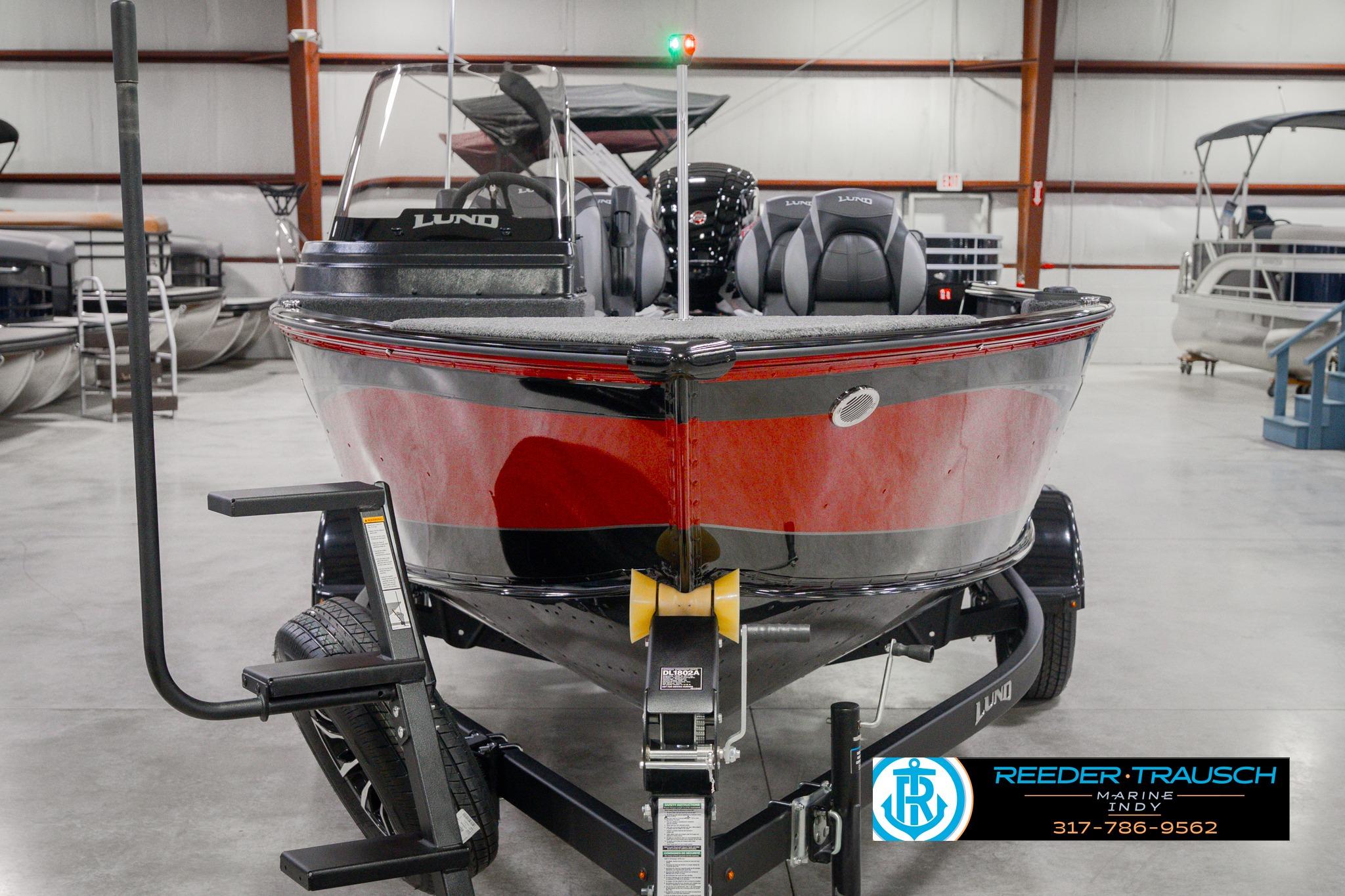 2026 Lund 1775 Impact XS SS boat in showroom, front view, on trailer.