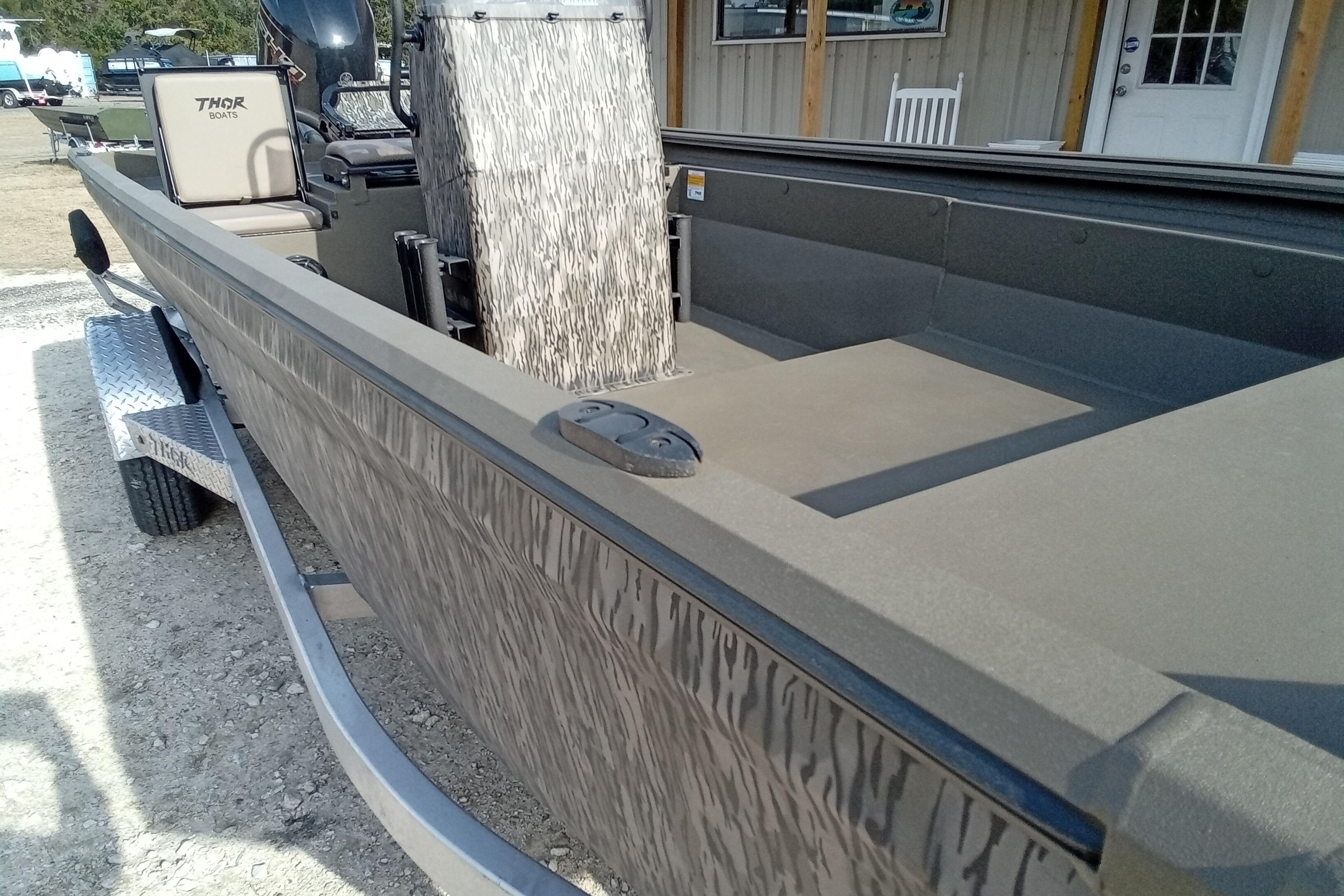 2026 Thor 1900 Low Country Elite boat on trailer, featuring camouflage design.