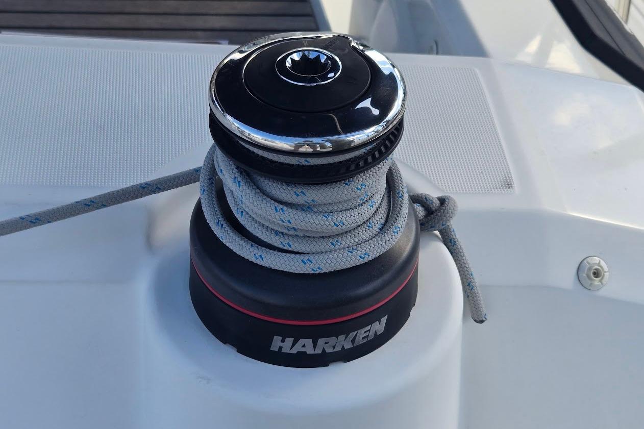 Winch on 2023 Beneteau Oceanis 38.1 sailboat with Harken branding and coiled rope.