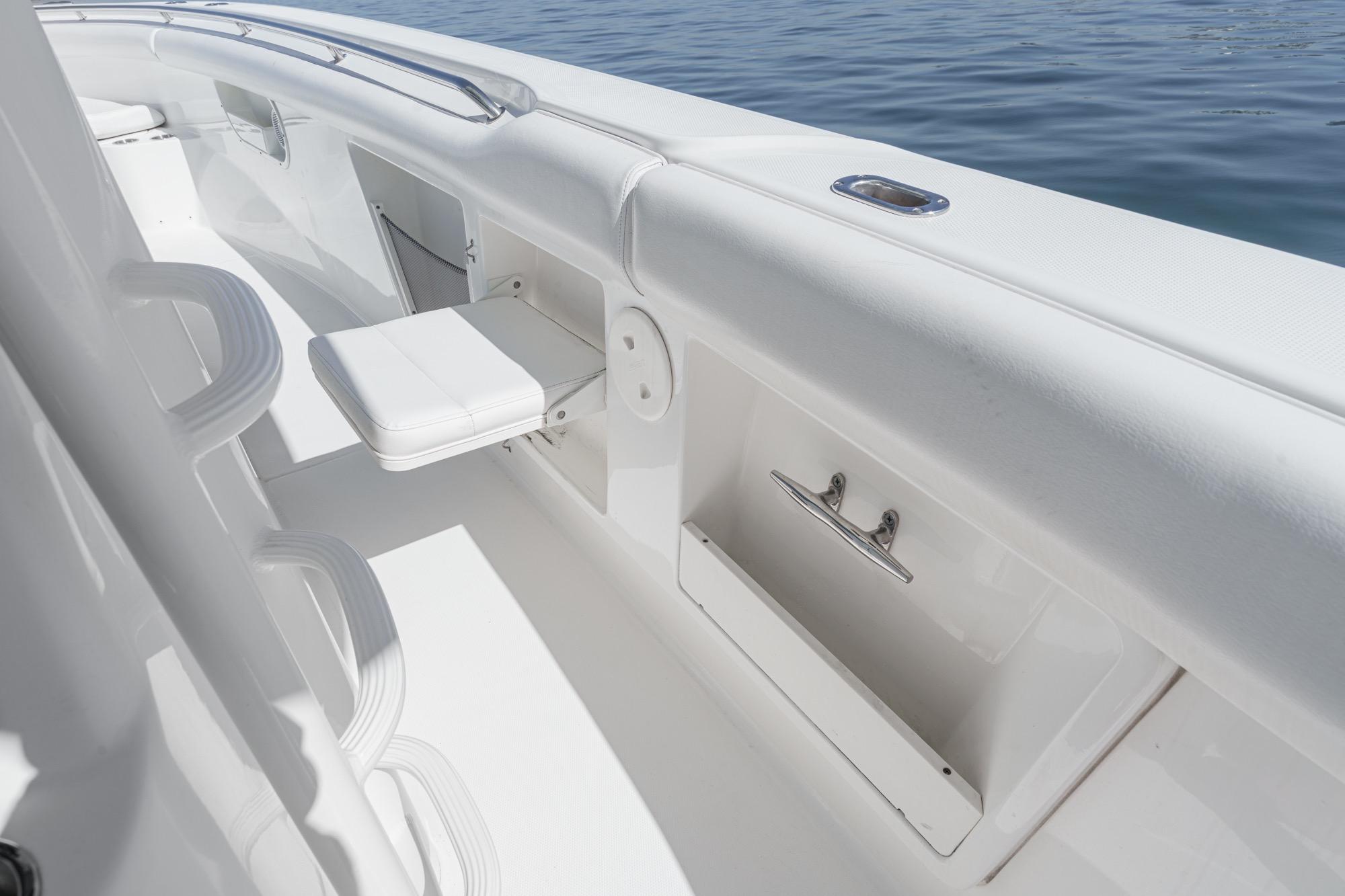 2015 Boston Whaler 370 Outrage boat interior with seating and storage, on calm water.