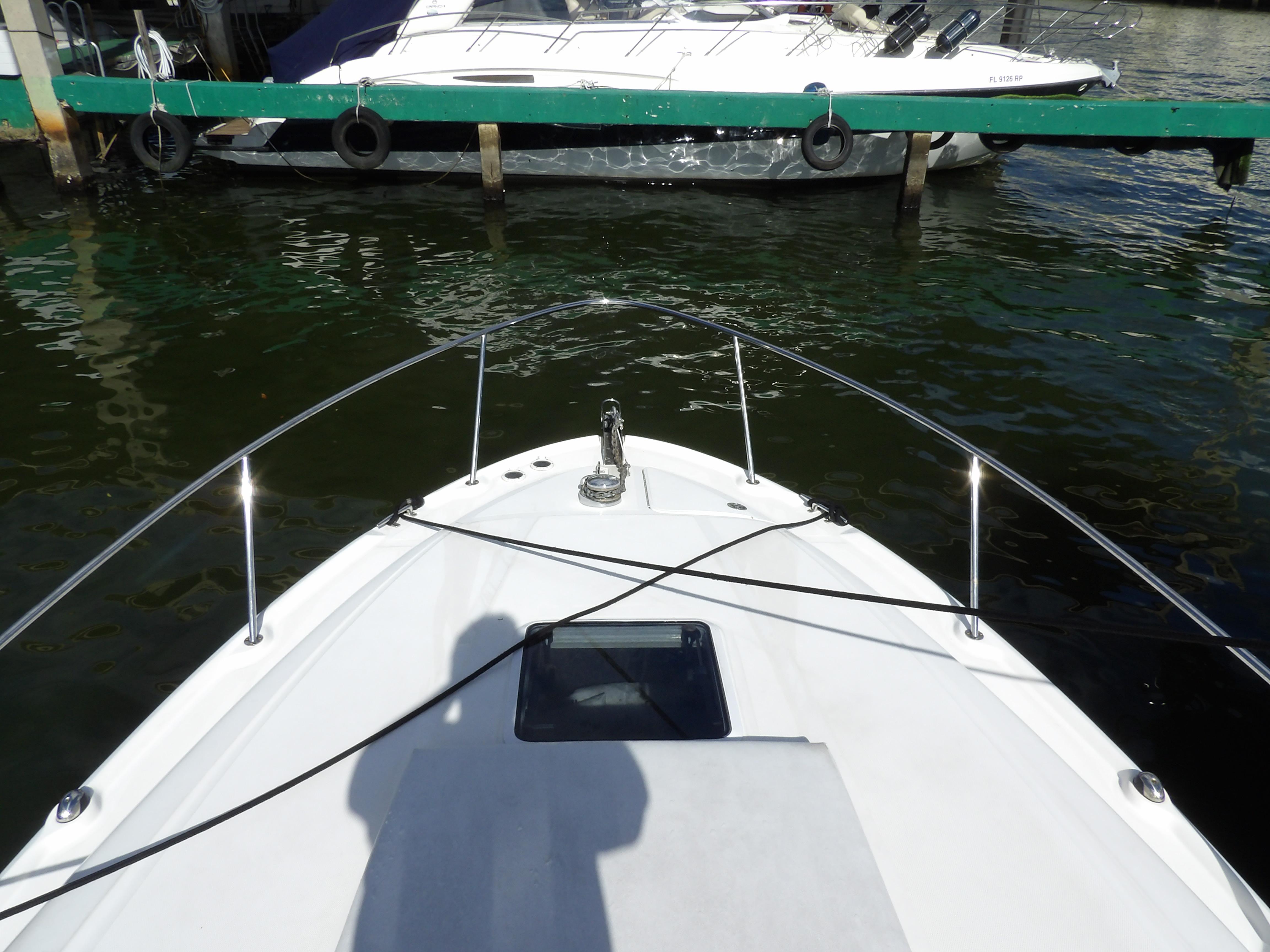 Bow view of 2004 Sea Ray 320 Sundancer docked in marina.