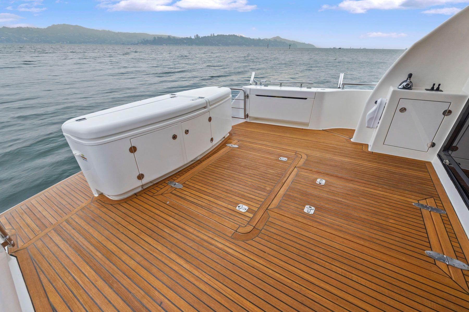 Spacious teak deck of 2014 Maritimo M50 yacht with ocean view.